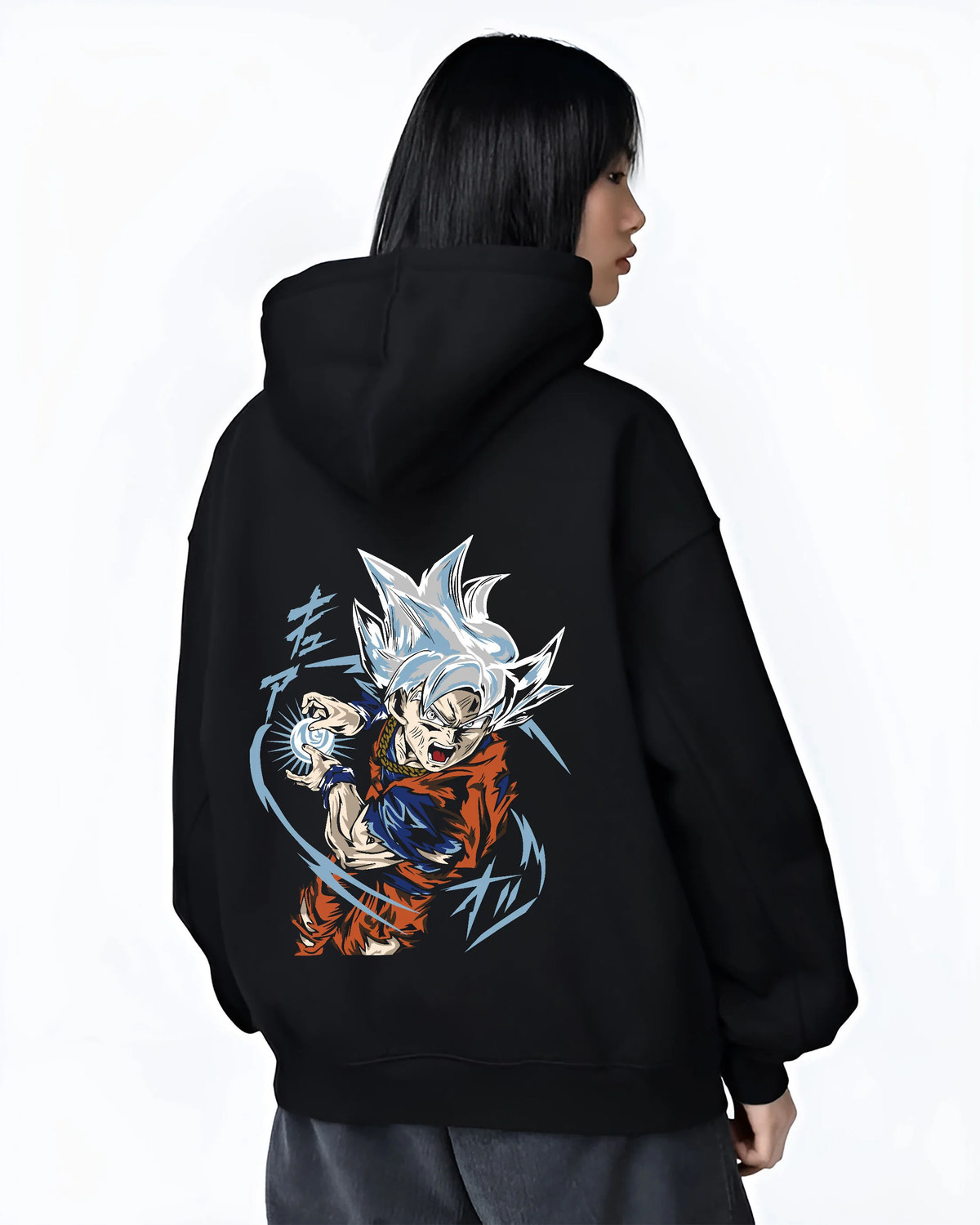 Black hoodie female model back view showing Goku from Dragon Ball Super: Ultra Instinct energy charge