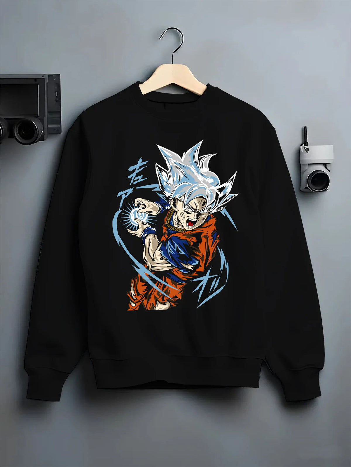Black crewneck sweatshirt on hanger showing Goku from Dragon Ball Super: Ultra Instinct energy charge