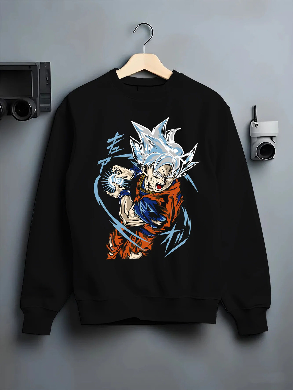 Black crewneck sweatshirt on hanger showing Goku from Dragon Ball Super: Ultra Instinct energy charge