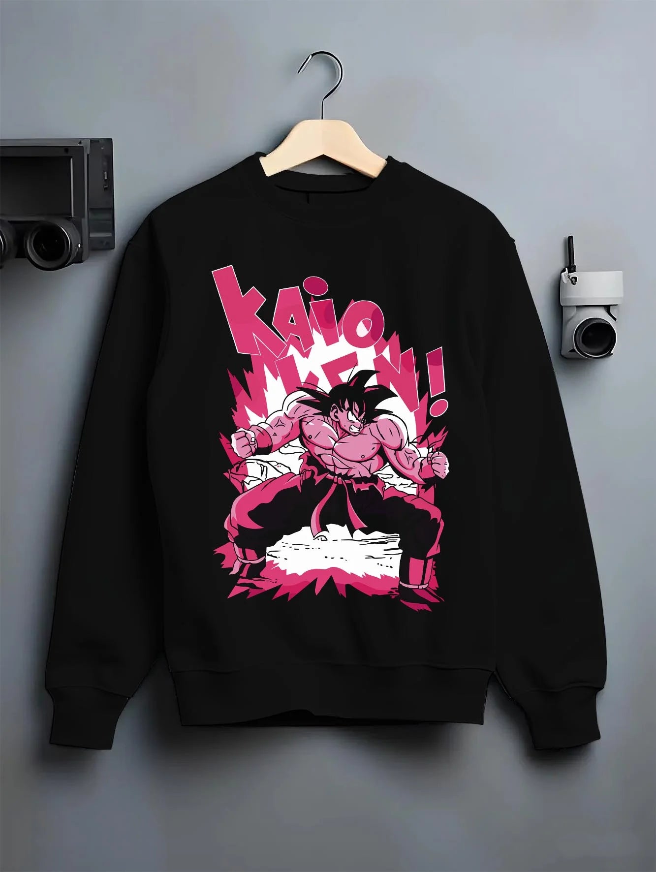 Black crewneck sweatshirt on hanger with Dragon Ball Z Hoodie Goku Kaio Ken Power Jumper graphic Goku themed artwork.
