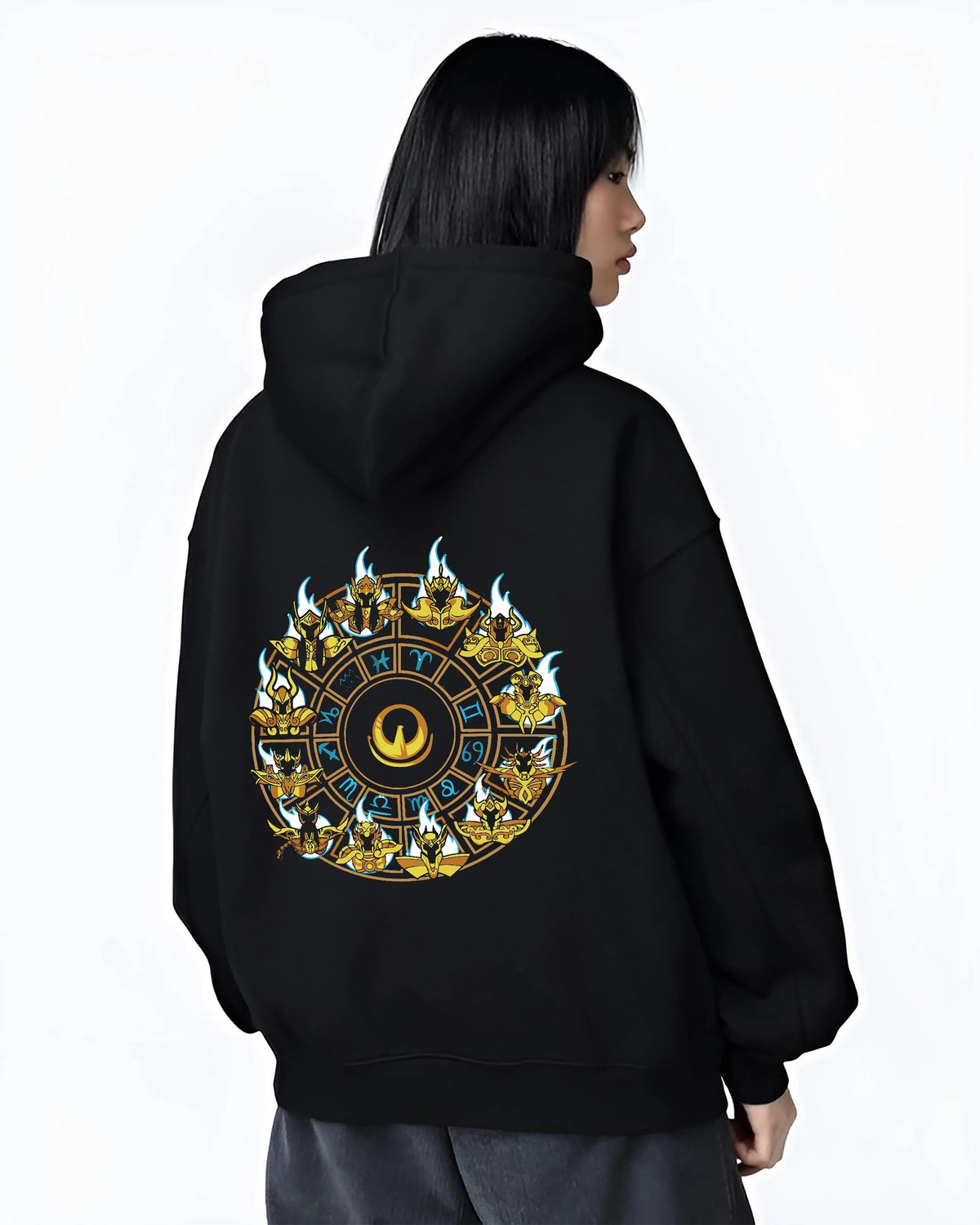 Black hoodie worn by female model from the back featuring Saint Seiya Gold Saints zodiac wheel artwork.