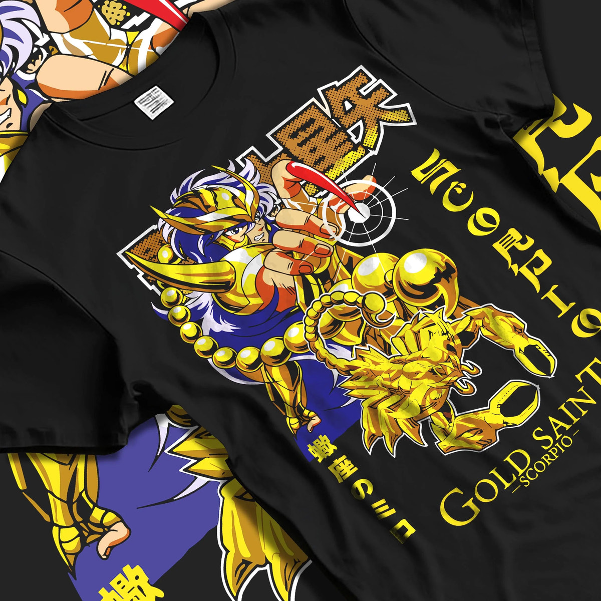 Black T-shirt laid flat with natural folds featuring Scorpio Milo Gold Saint cosmic armour artwork.