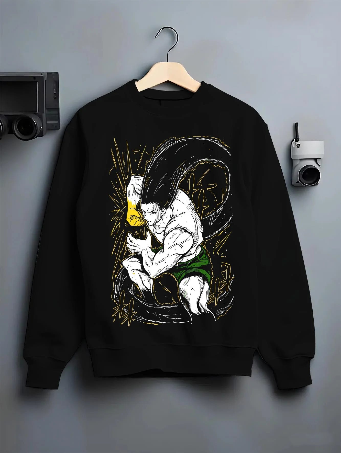 Black crewneck sweatshirt on hanger with Hunter x Hunter Hoodie Gon Freecss Determined Jumper graphic bold anime graphic.