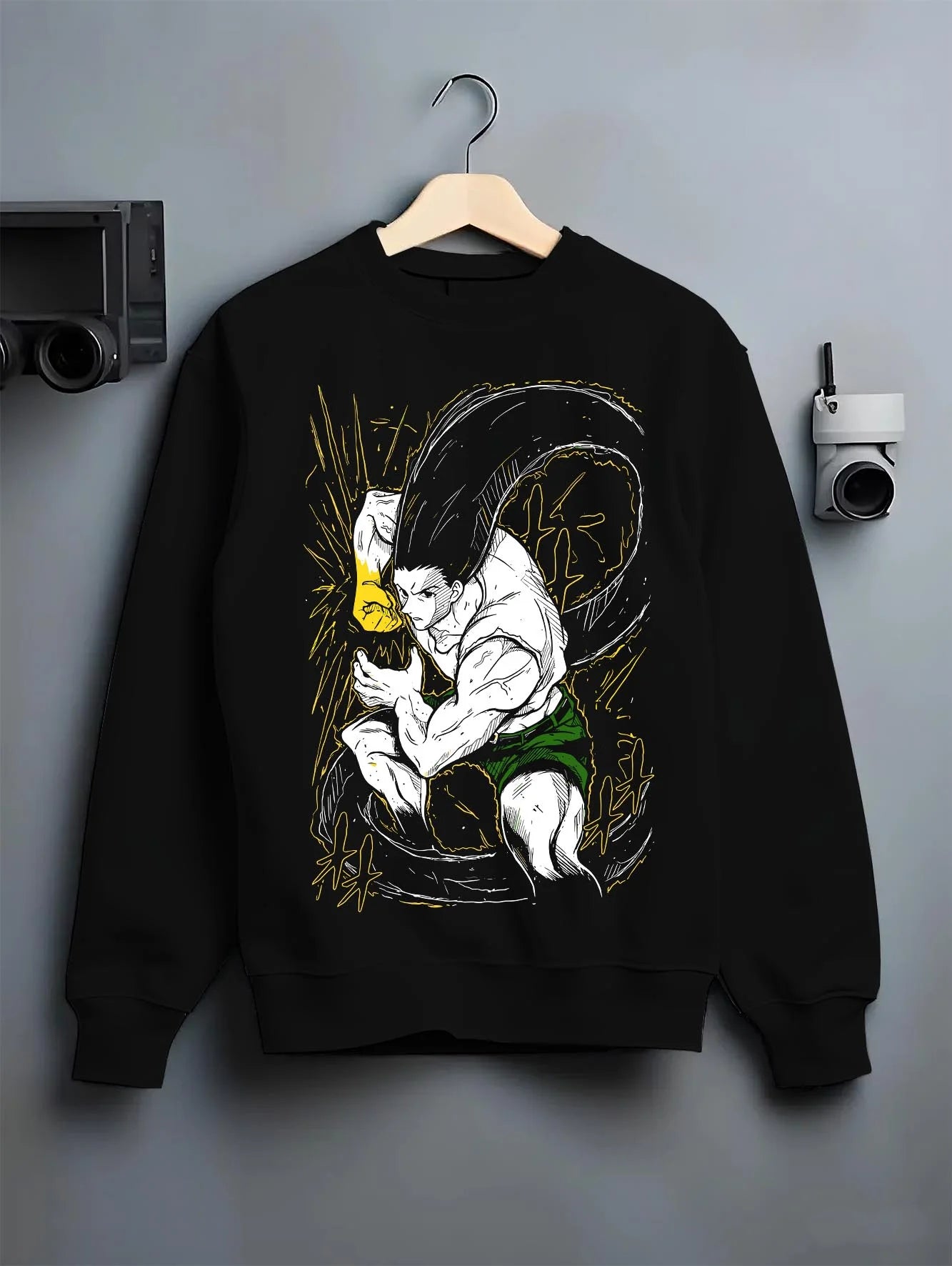 Black crewneck sweatshirt on hanger with Hunter x Hunter Hoodie Gon Freecss Determined Jumper graphic bold anime graphic.