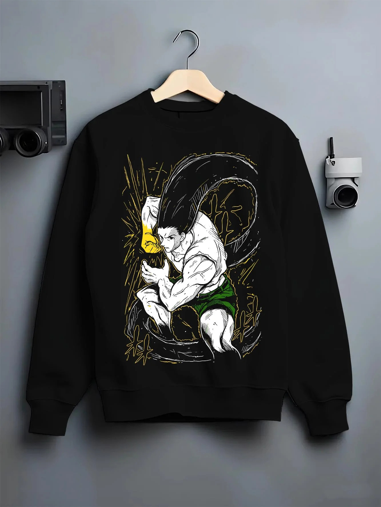 Black crewneck sweatshirt on hanger with Hunter x Hunter Hoodie Gon Freecss Determined Jumper graphic bold anime graphic.
