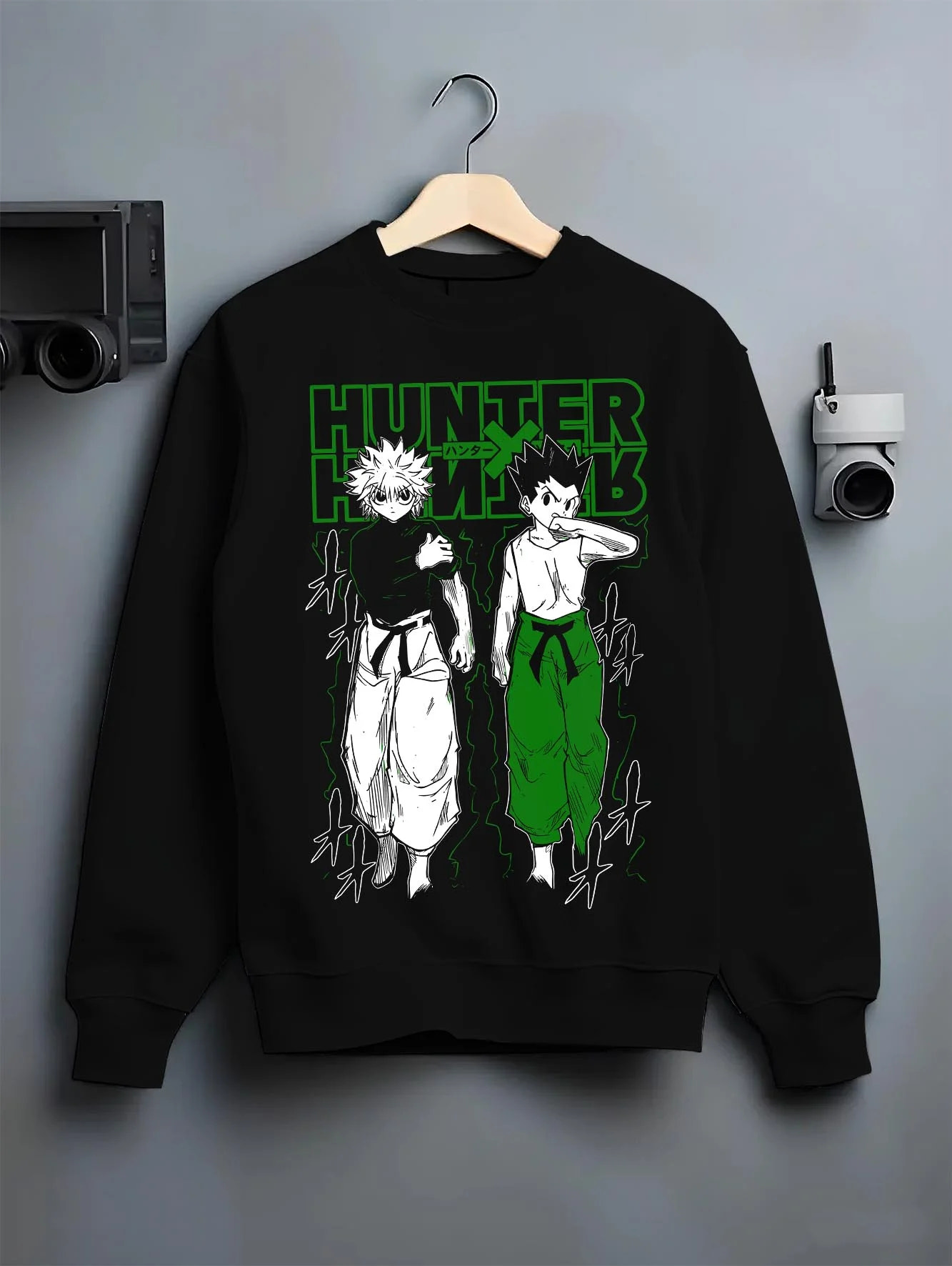 Black crewneck sweatshirt on hanger with Hunter x Hunter Hoodie Gon Killua Logo Jumper graphic streetwear graphic.