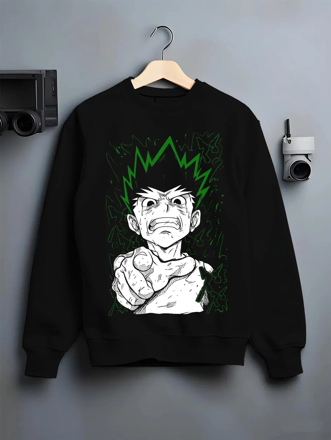 Black crewneck sweatshirt on hanger with Hunter x Hunter Hoodie Gon Freecss Strength Jumper graphic bold anime graphic.