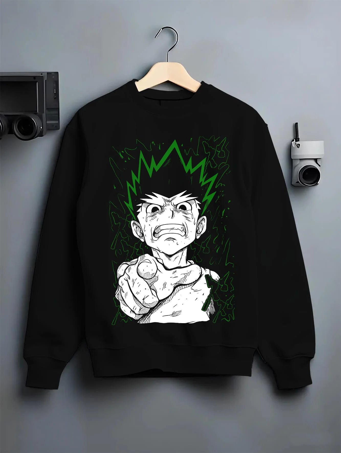 Black crewneck sweatshirt on hanger with Hunter x Hunter Hoodie Gon Freecss Strength Jumper graphic bold anime graphic.