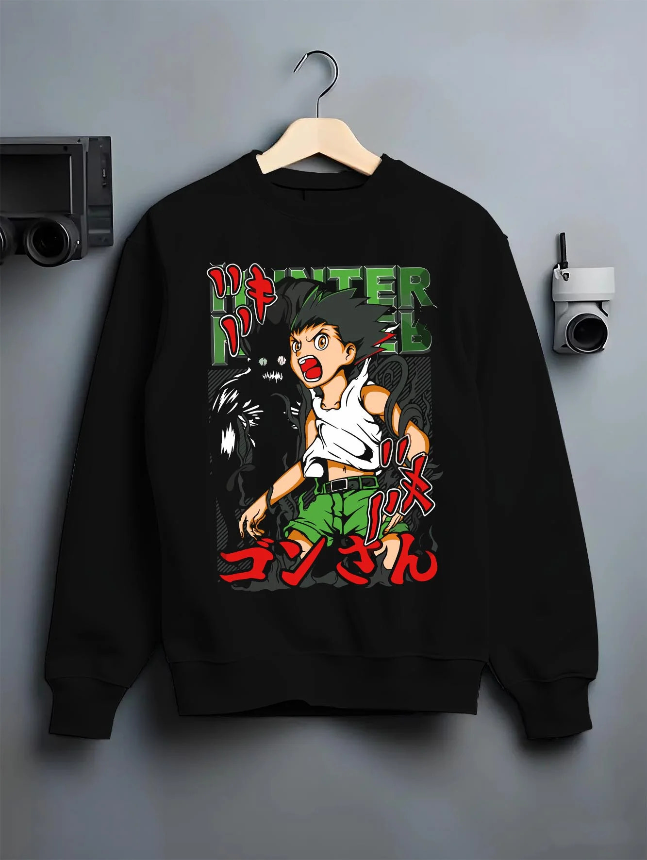 Black crewneck sweatshirt on hanger with Hunter x Hunter Hoodie Gon Freecss Power Jumper graphic premium wear.