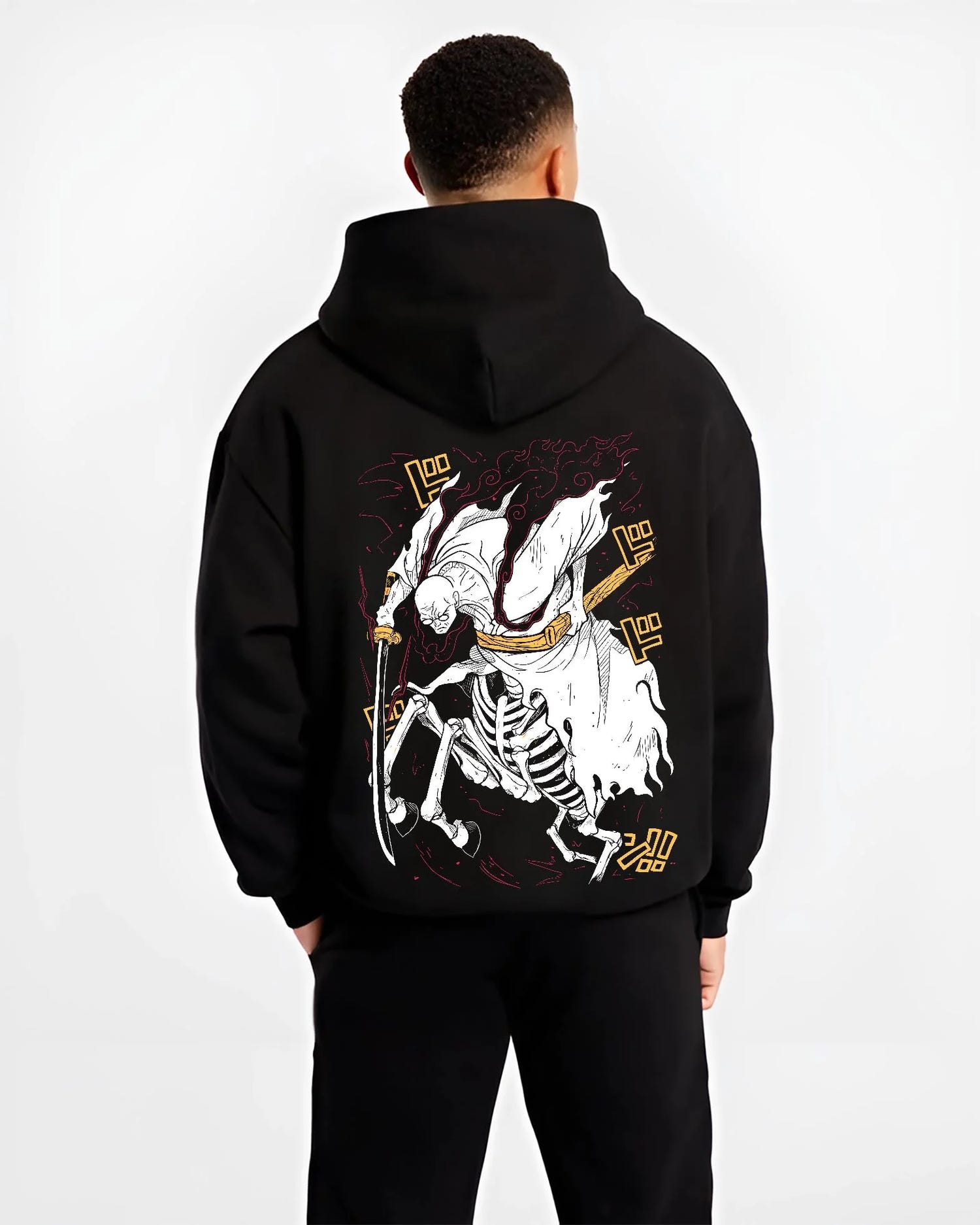 Black hoodie worn by male model, back view with One Piece Hoodie Brook Soul King Rising Jumper graphic bold anime graphic.