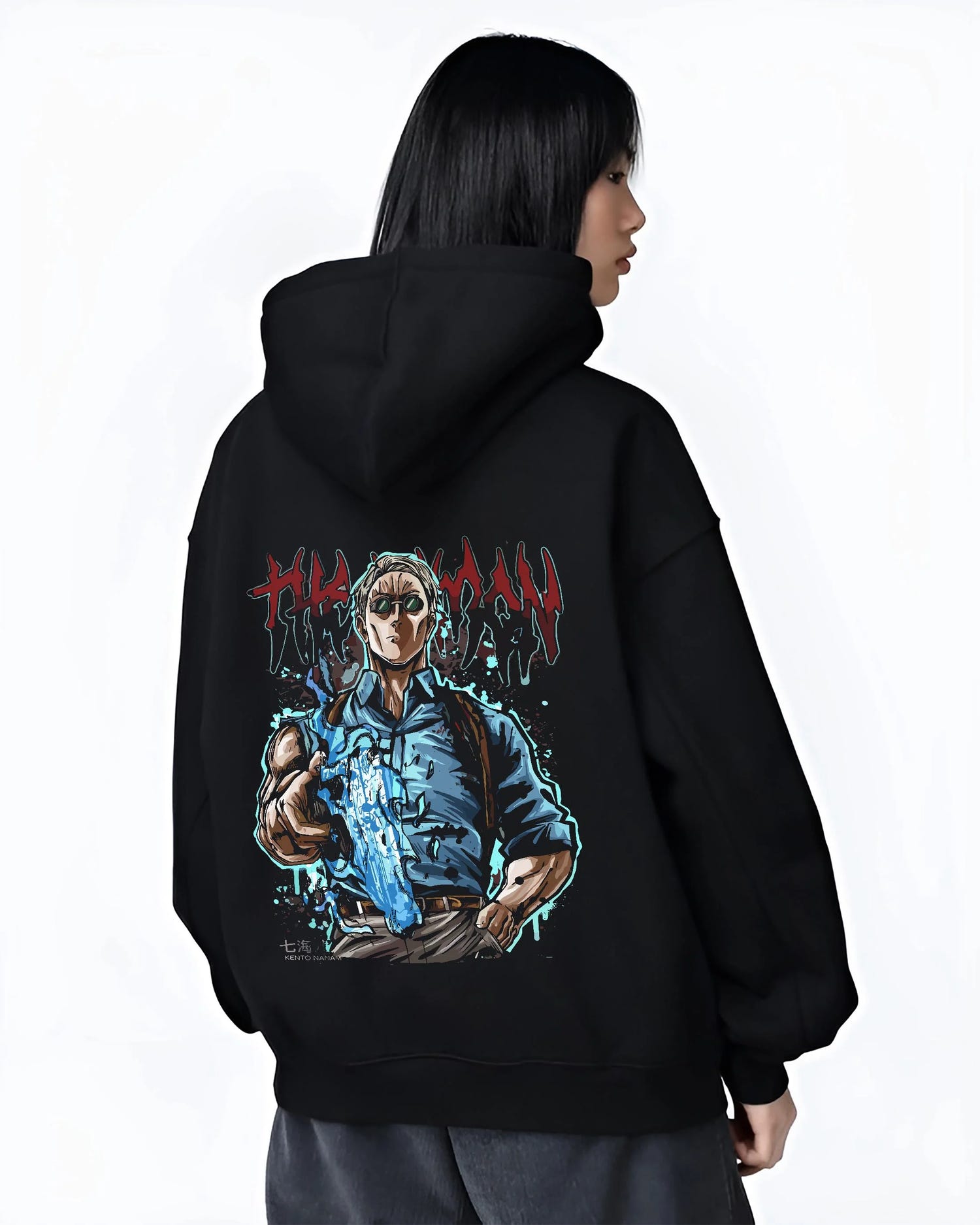 Black hoodie worn by female model, back view, featuring retro streetwear graphic of Nanami Kento with cursed blade artwork.