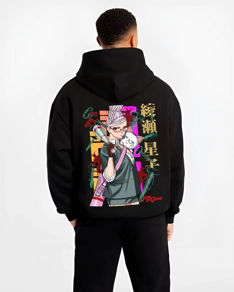 Black hoodie worn by a male model, back view, featuring Dandadan Aira Shiratori retro manga artwork print with hammers and cat companion.
