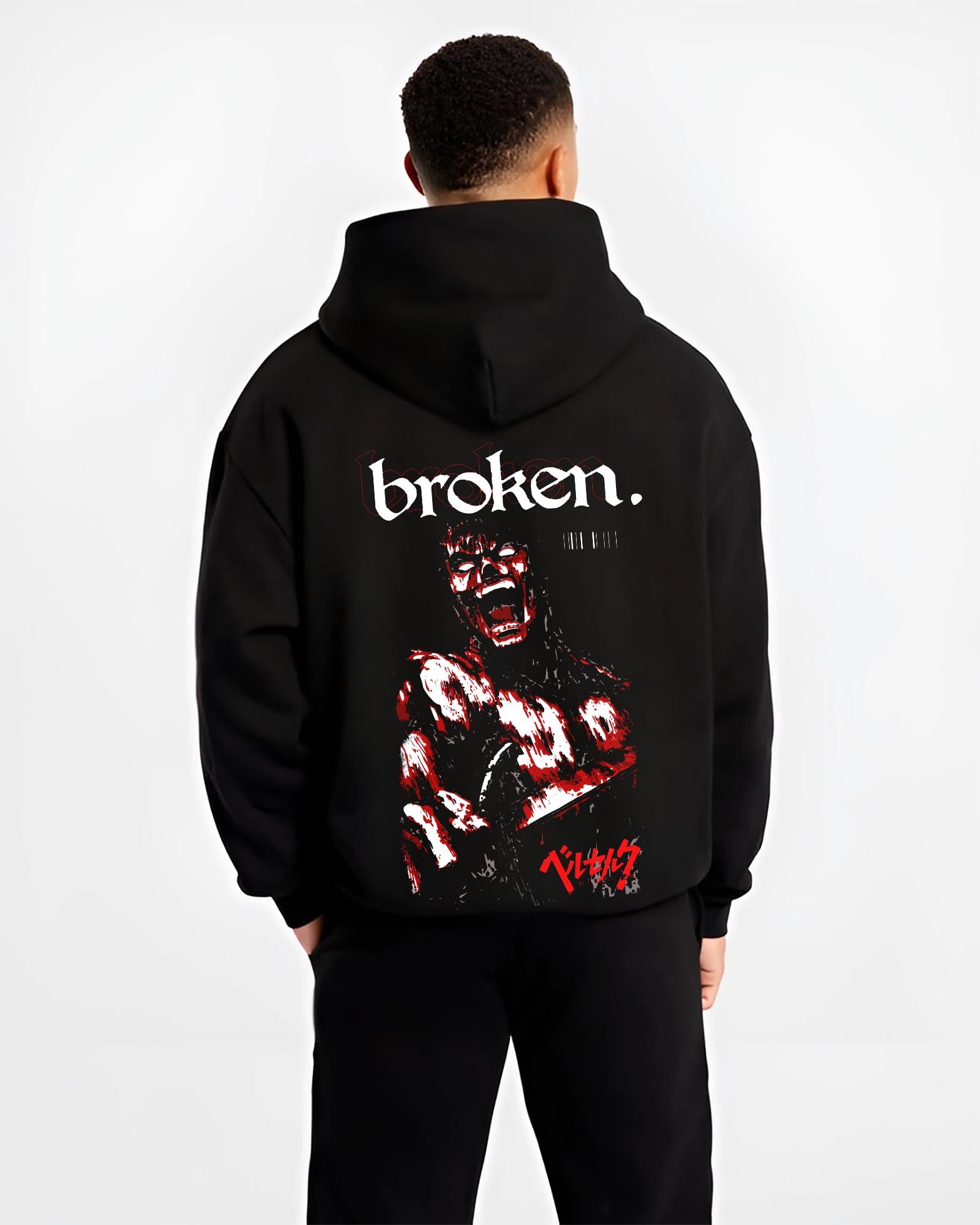 Black hoodie worn by a male model, back view, featuring Berserk Guts dark manga panel inspired artwork with blood-splattered retro streetwear graphic design.