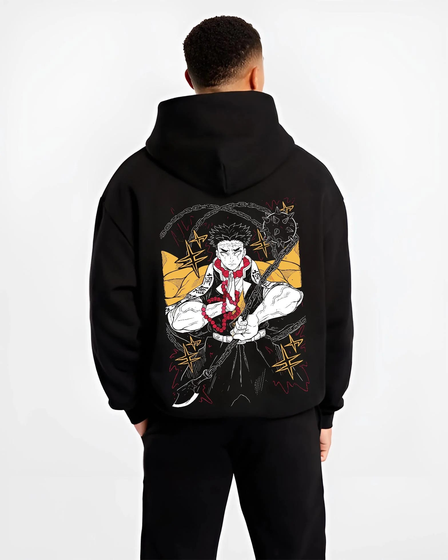 Black hoodie worn by male model, back view with Demon Slayer Hoodie Gyomei Himejima Prayer Pose Jumper graphic bold anime graphic.