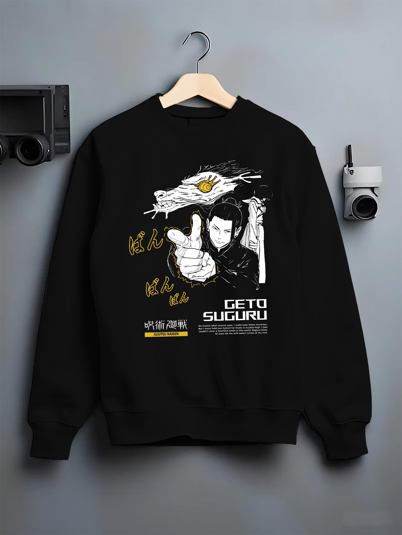 Black crewneck sweatshirt on a hanger against a grey wall, featuring Geto Suguru anime poster inspired artwork in dark manga panel style with retro streetwear vibe.