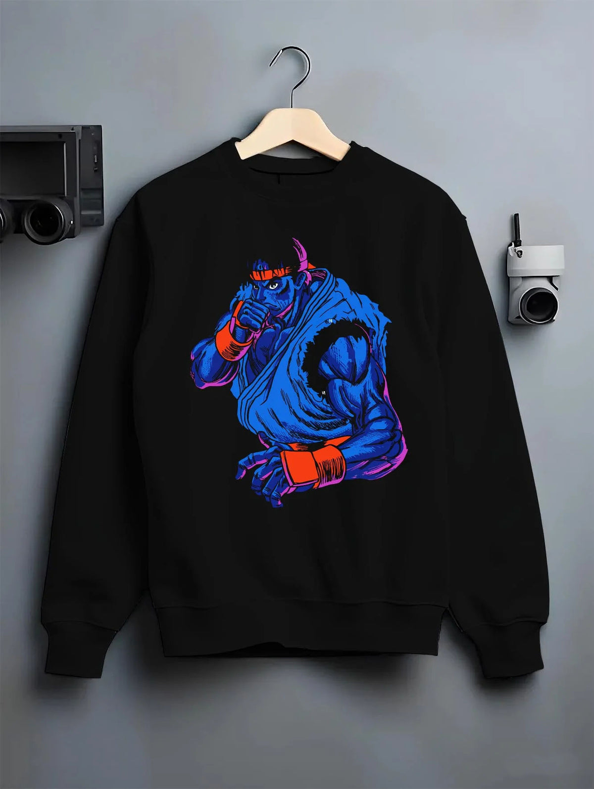 Black crewneck sweatshirt on hanger featuring Ryu blue gi Hadouken battle artwork.