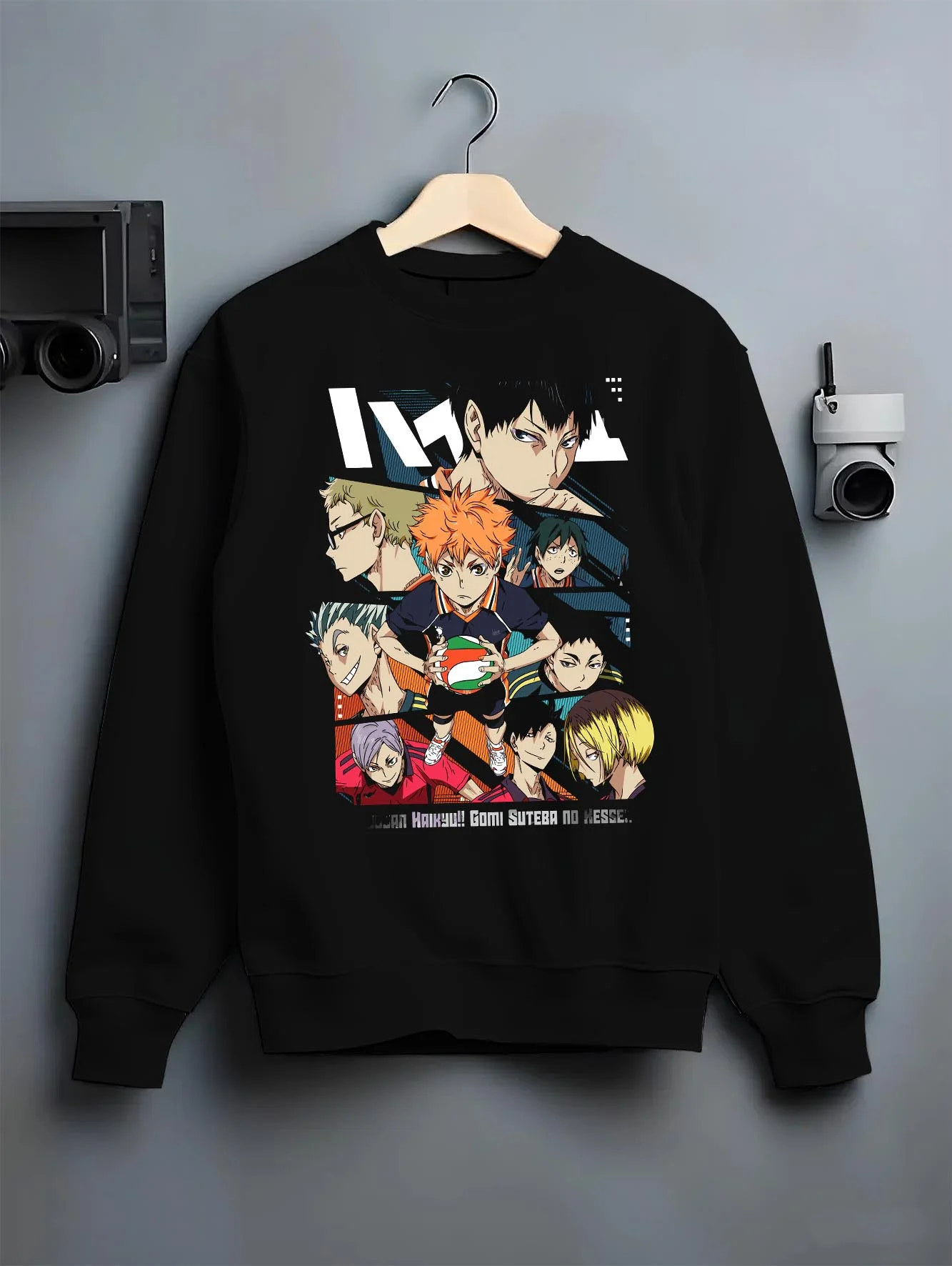 Black crewneck sweatshirt on hanger with Haikyuu Hoodie Shoyo Hinata Team Spirit Jumper graphic streetwear graphic.