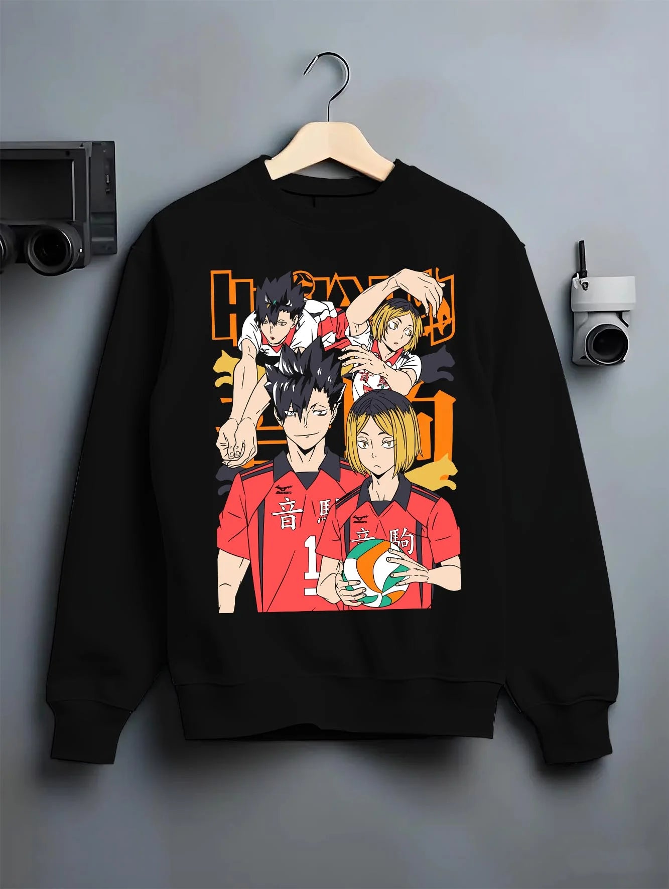 Black crewneck sweatshirt on hanger with Haikyuu Hoodie Nekoma vs Karasuno Rival Jumper graphic nan themed artwork.