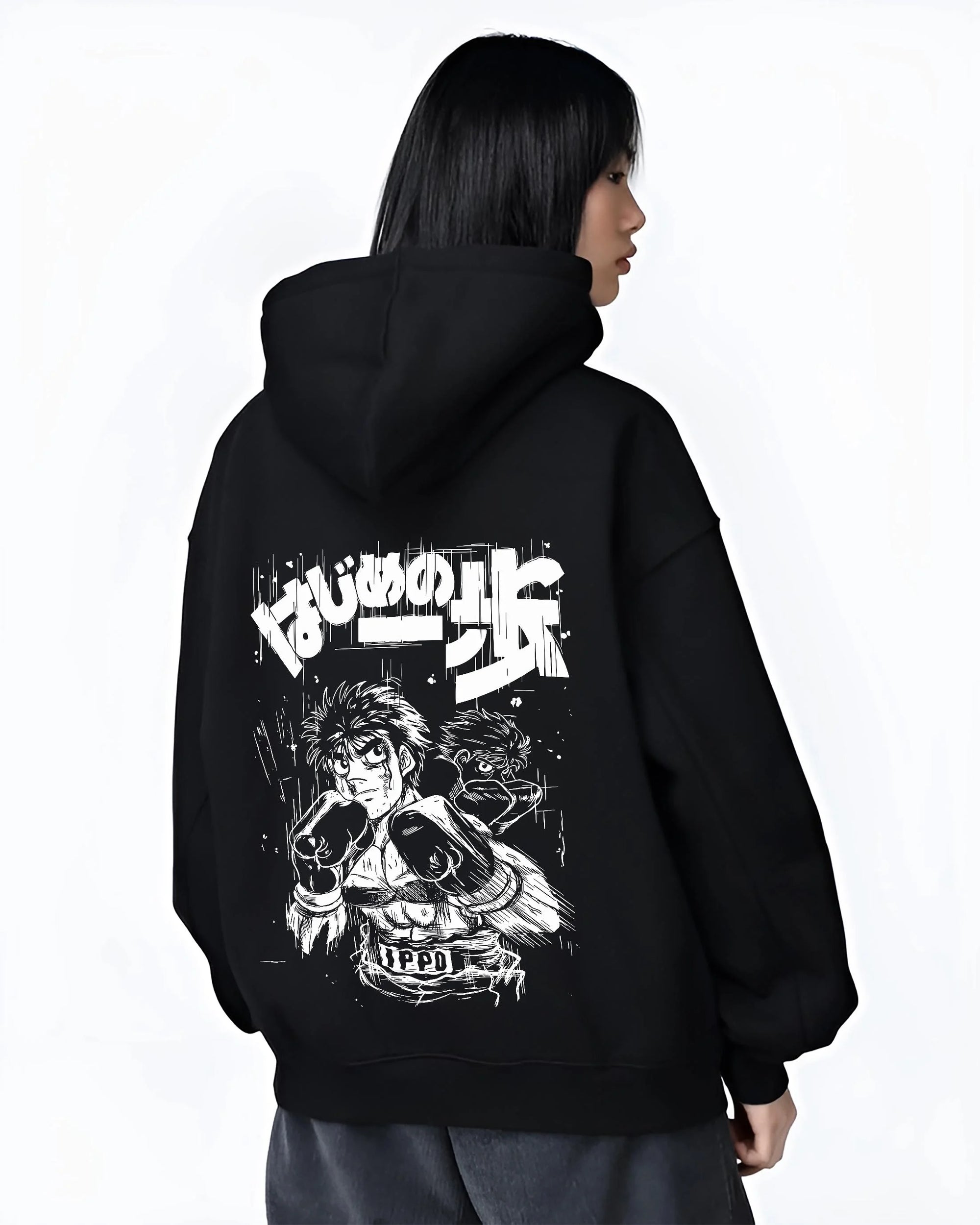 Black hoodie worn by female model, back view with Hajime no Ippo Hoodie Ippo Makunouchi Fighting Spirit graphic premium wear.