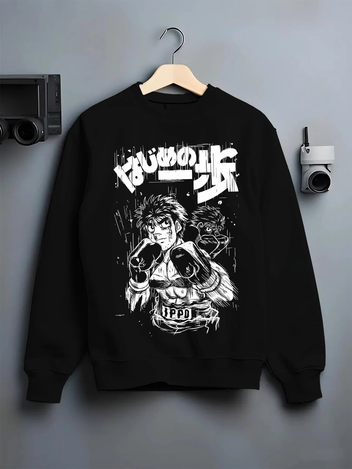 Black crewneck sweatshirt on hanger with Hajime no Ippo Hoodie Ippo Makunouchi Fighting Spirit graphic bold anime graphic.