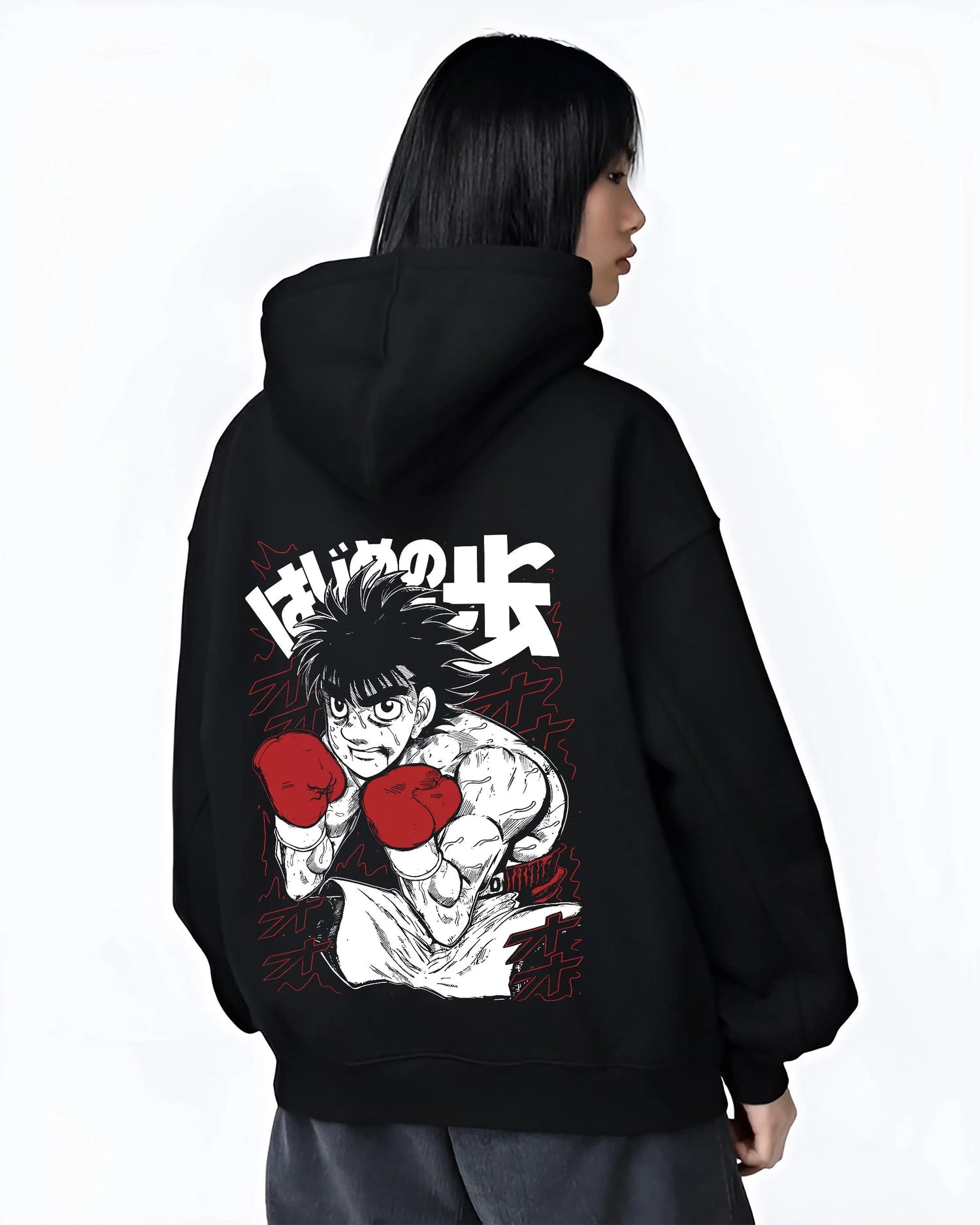Black hoodie worn by female model, back view with Hajime no Ippo Hoodie Ippo Makunouchi Strong Punch graphic bold anime graphic.