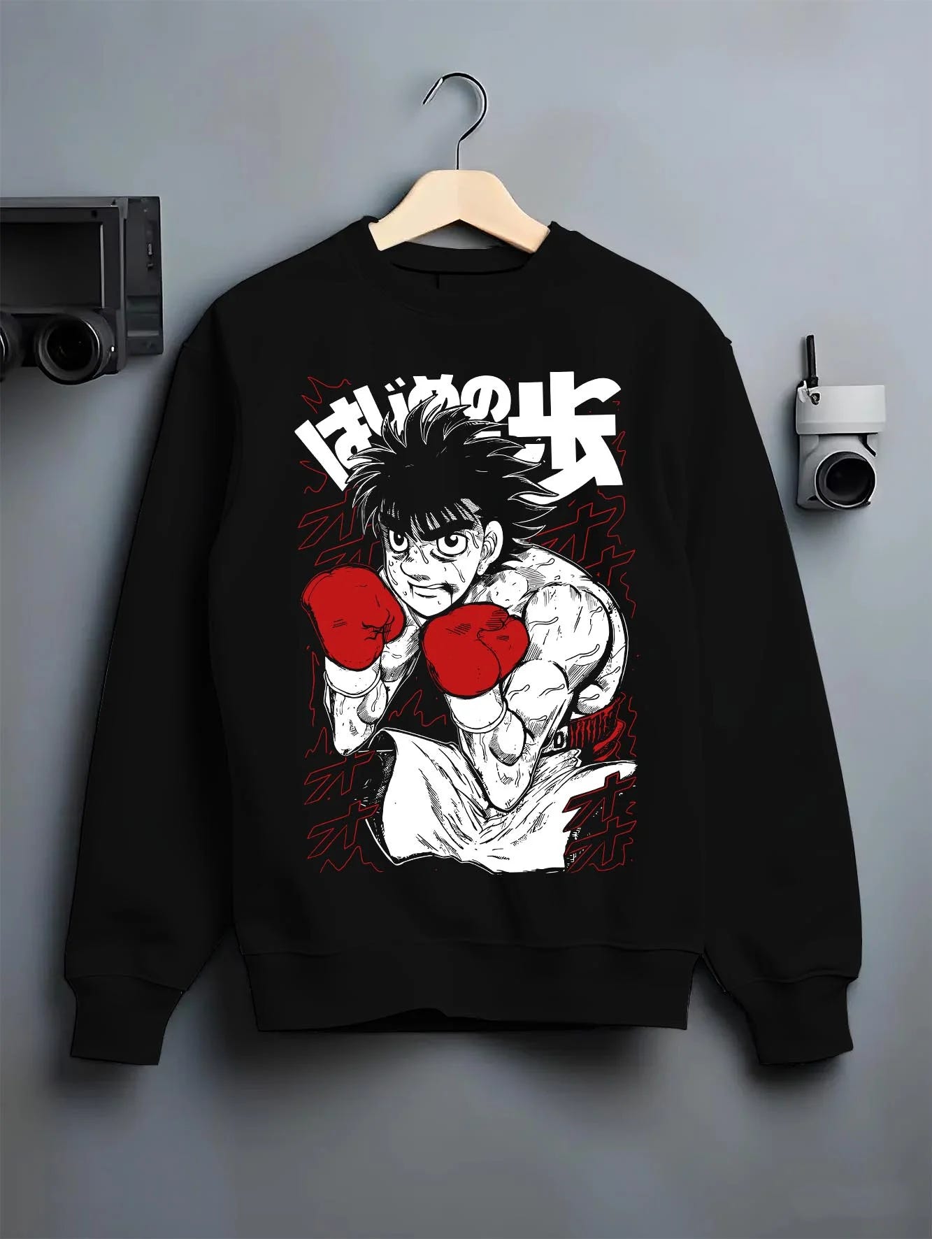 Black crewneck sweatshirt on hanger with Hajime no Ippo Hoodie Ippo Makunouchi Strong Punch graphic premium wear.