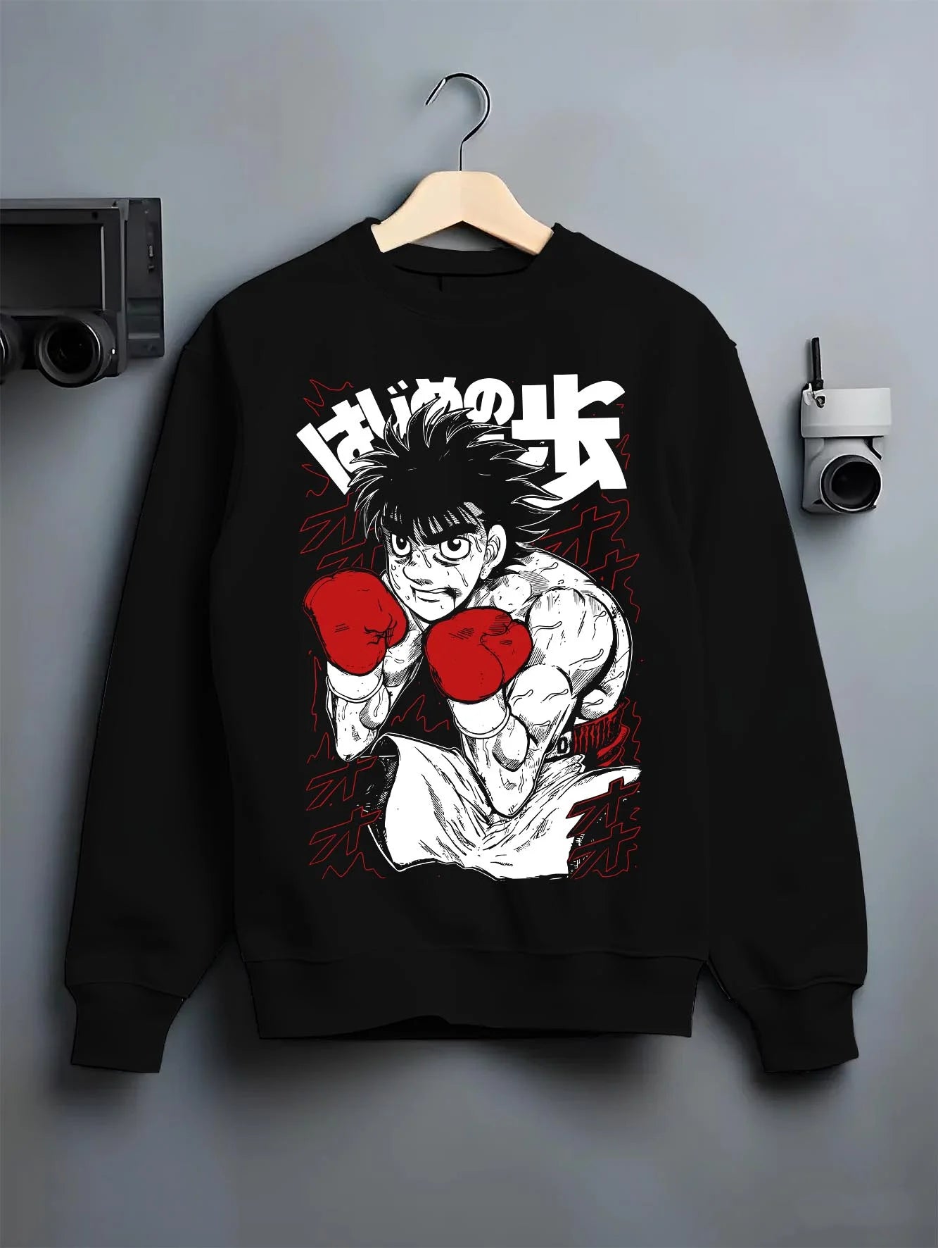 Black crewneck sweatshirt on hanger with Hajime no Ippo Hoodie Ippo Makunouchi Strong Punch graphic premium wear.