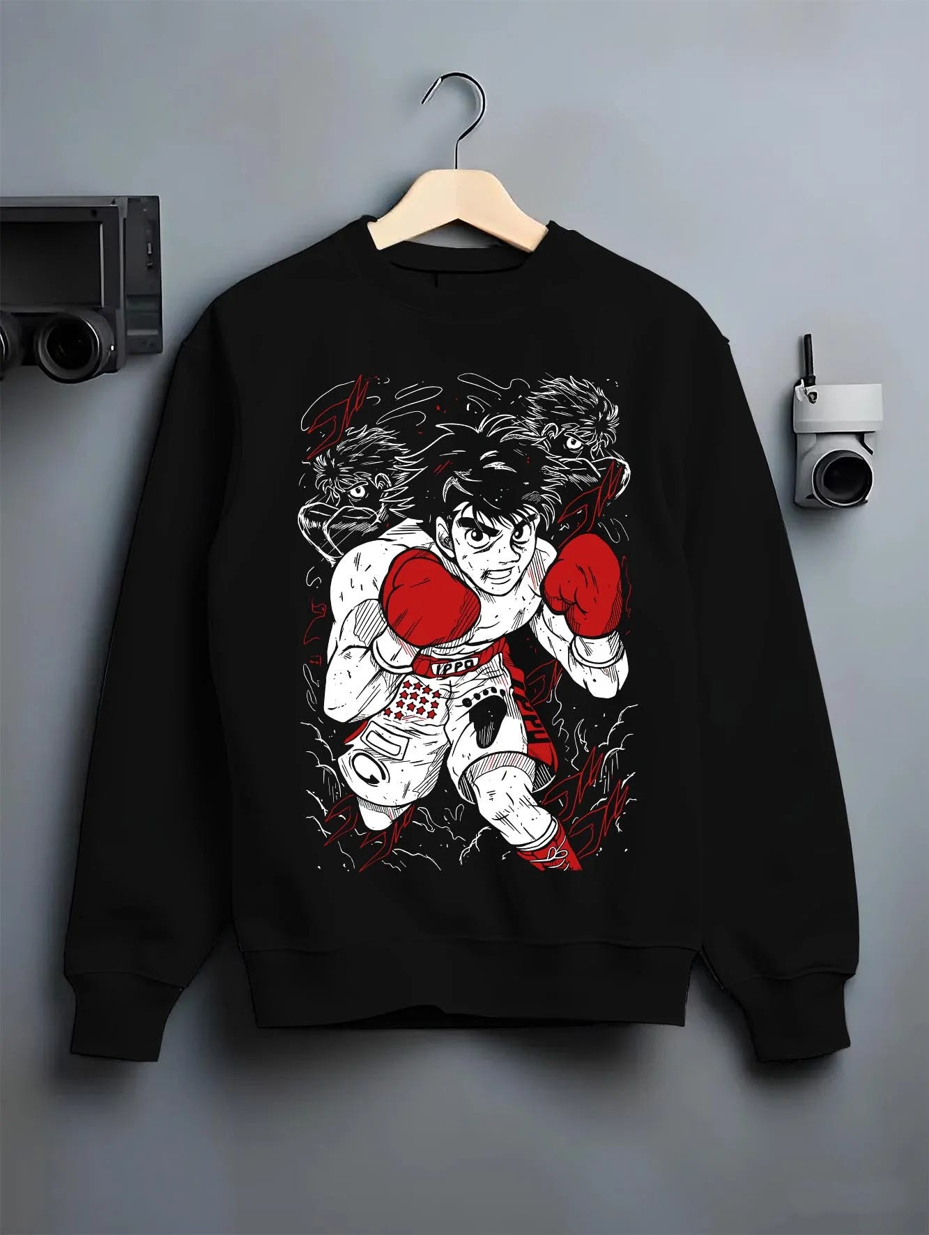 Black crewneck sweatshirt on hanger with Hajime no Ippo Hoodie Ippo Makunouchi Ultimate Fighter graphic streetwear graphic.
