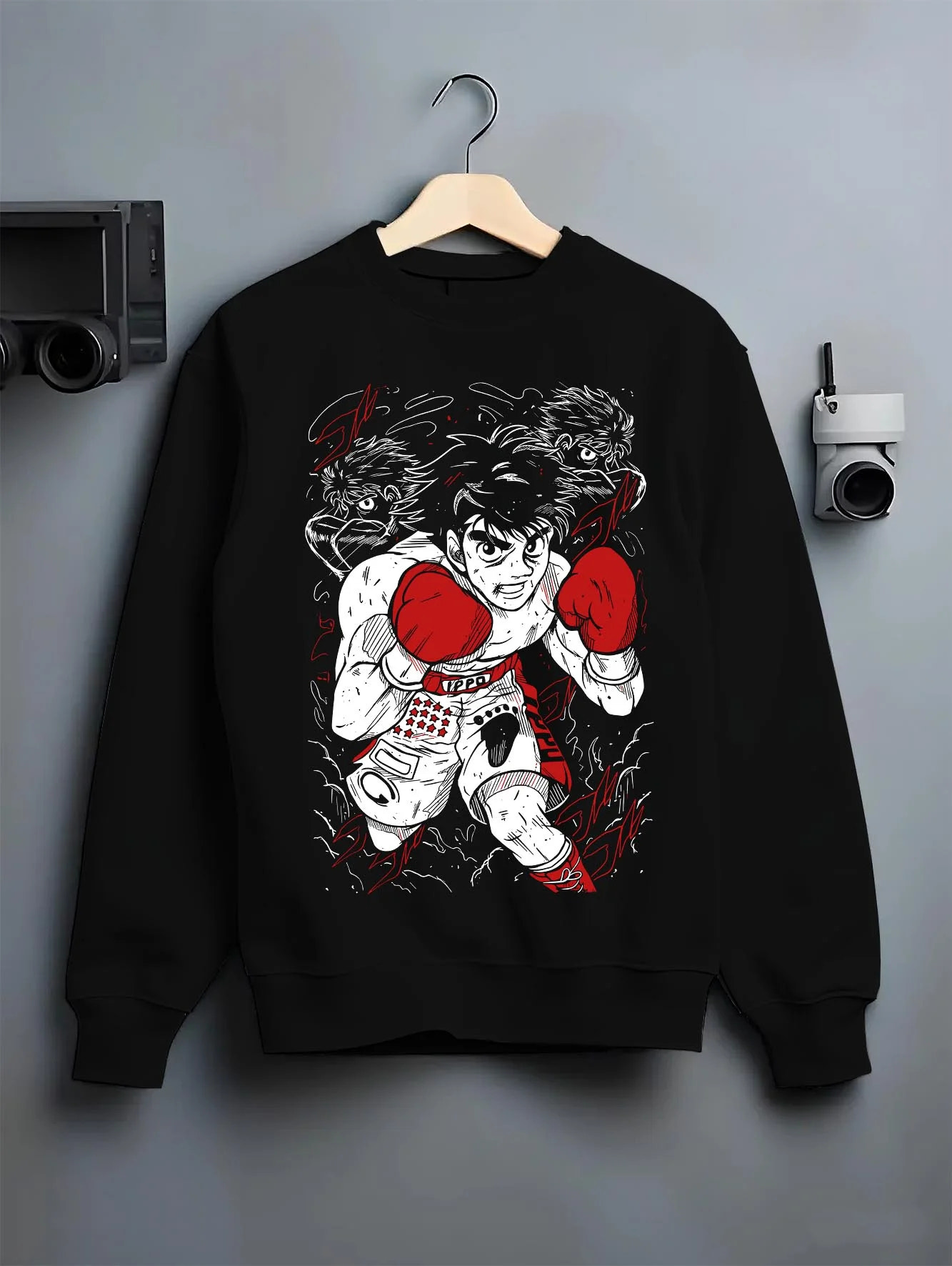 Black crewneck sweatshirt on hanger with Hajime no Ippo Hoodie Ippo Makunouchi Ultimate Fighter graphic streetwear graphic.