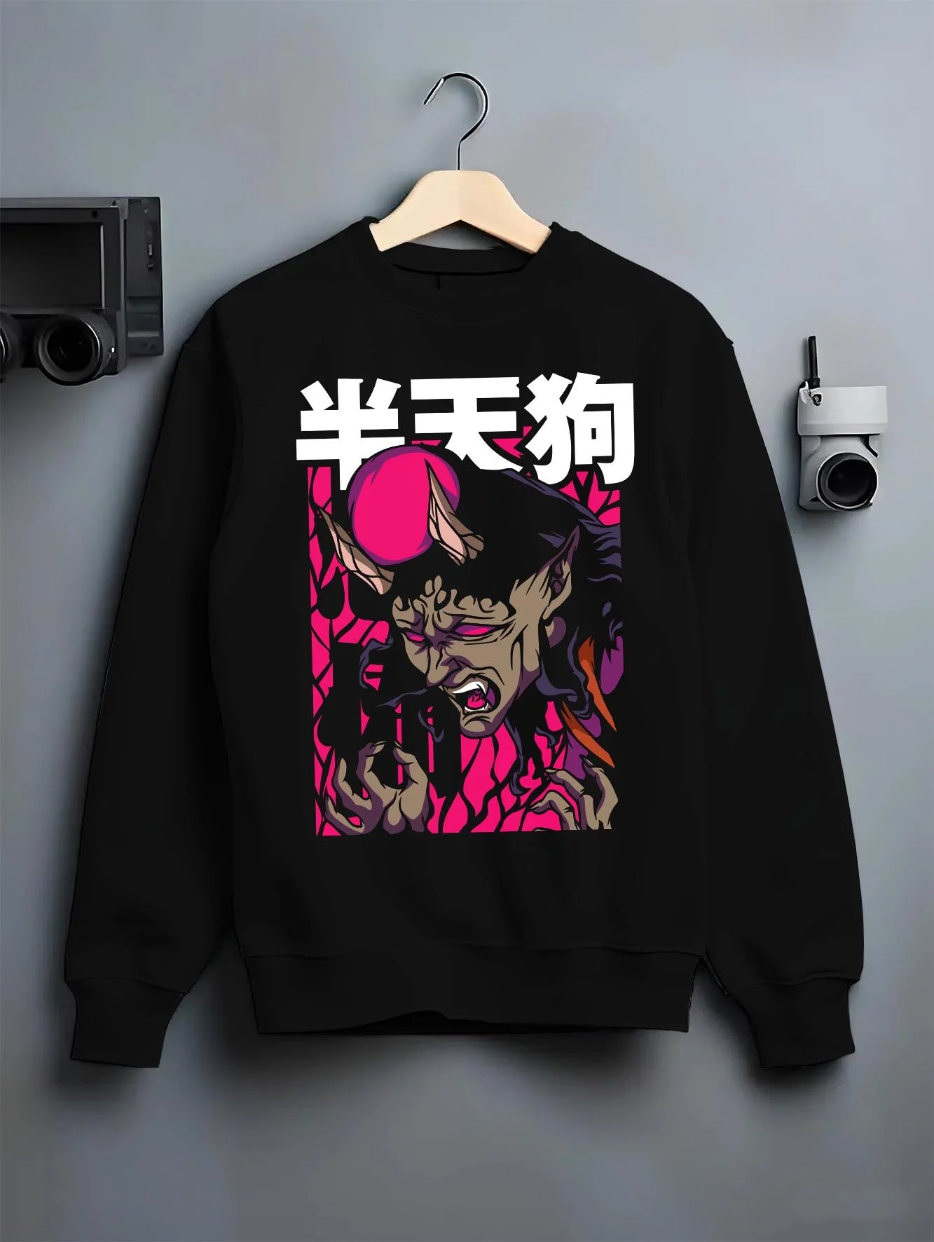 Black crewneck sweatshirt on hanger featuring Japanese yokai demon anime poster inspired design with retro streetwear graphic styling.