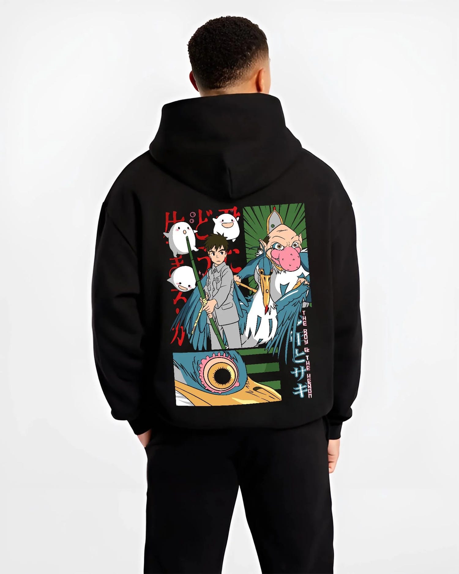 Black hoodie worn by male model, back view with The Boy And The Heron Hoodie Studio Ghibli Movie graphic bold anime graphic.