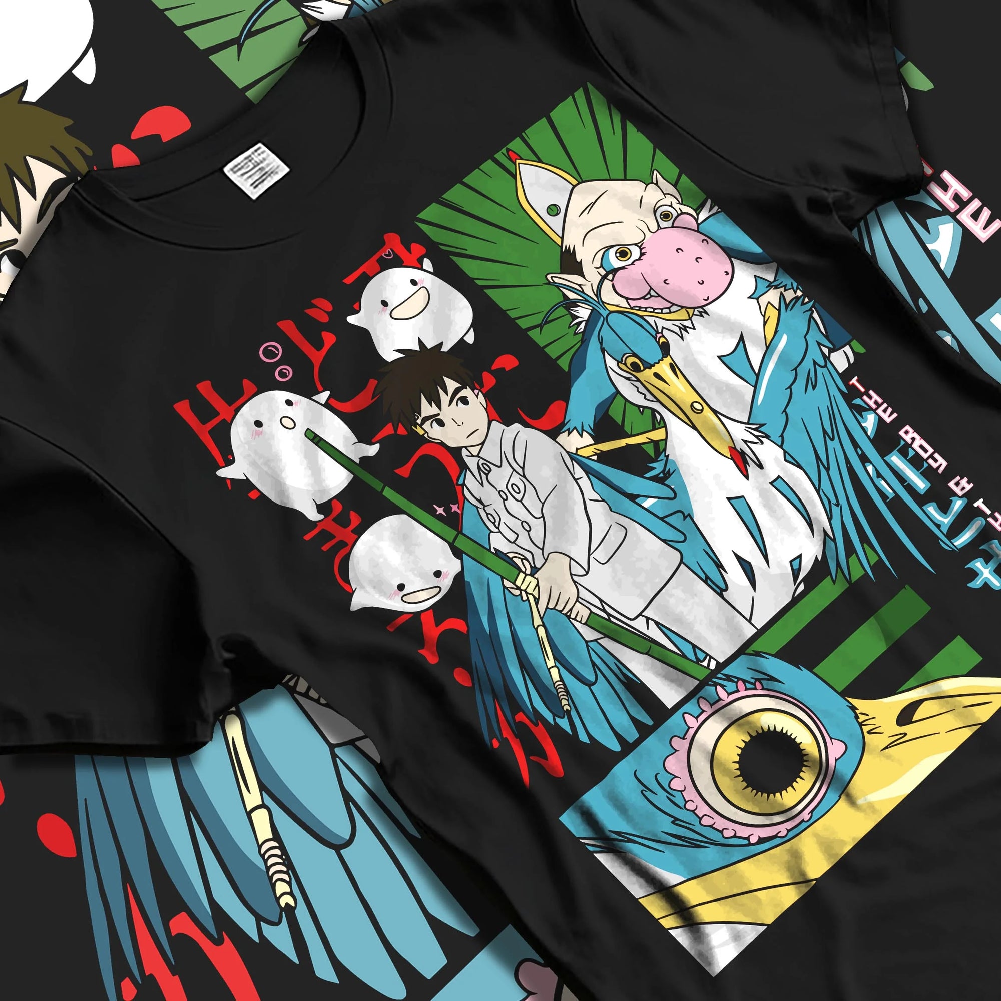 Black T-shirt laid flat with natural folds with The Boy And The Heron Hoodie Studio Ghibli Movie graphic streetwear graphic.