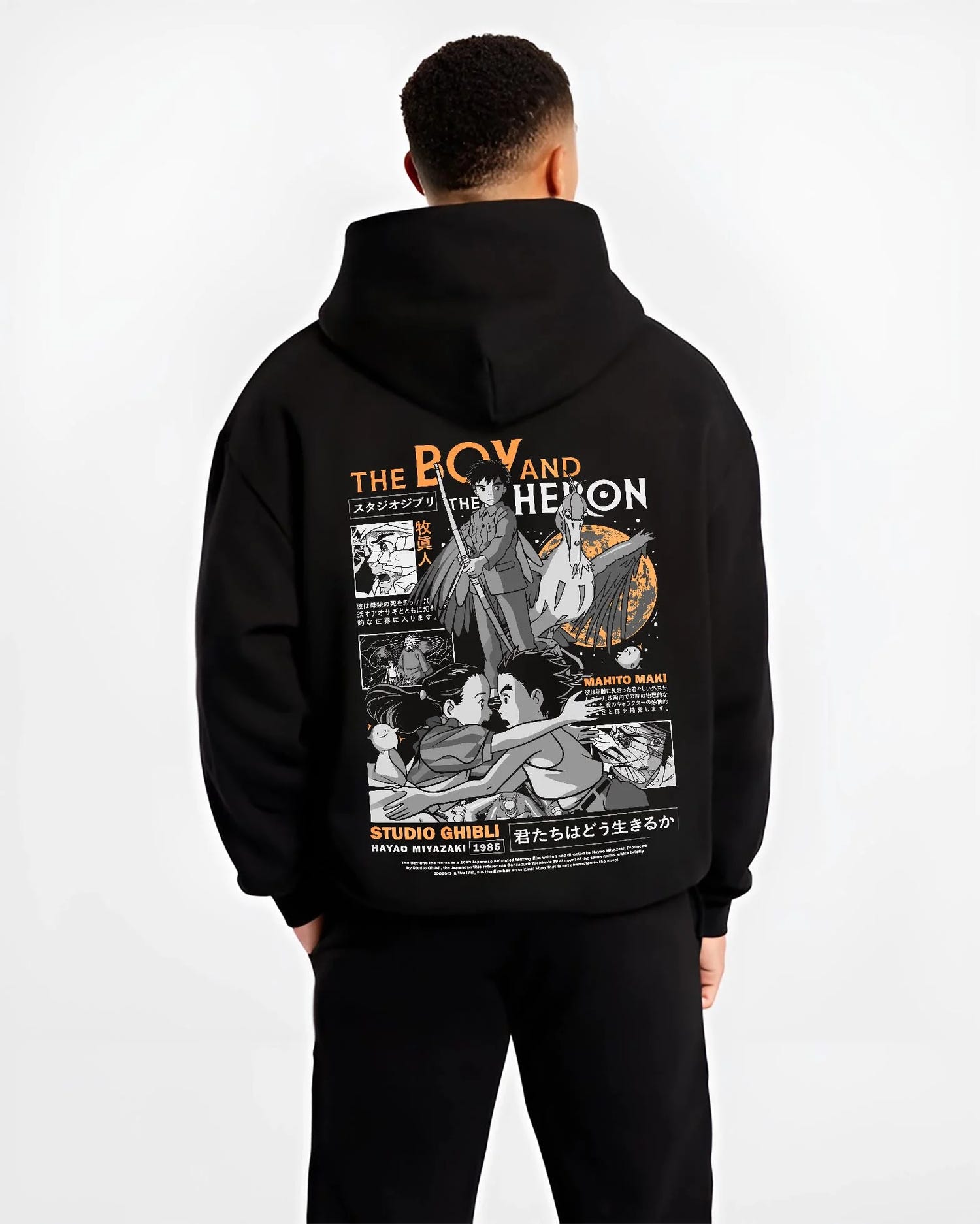 Black hoodie worn by male model, back view with The Boy And The Heron Hoodie Studio Ghibli Cover graphic streetwear graphic.