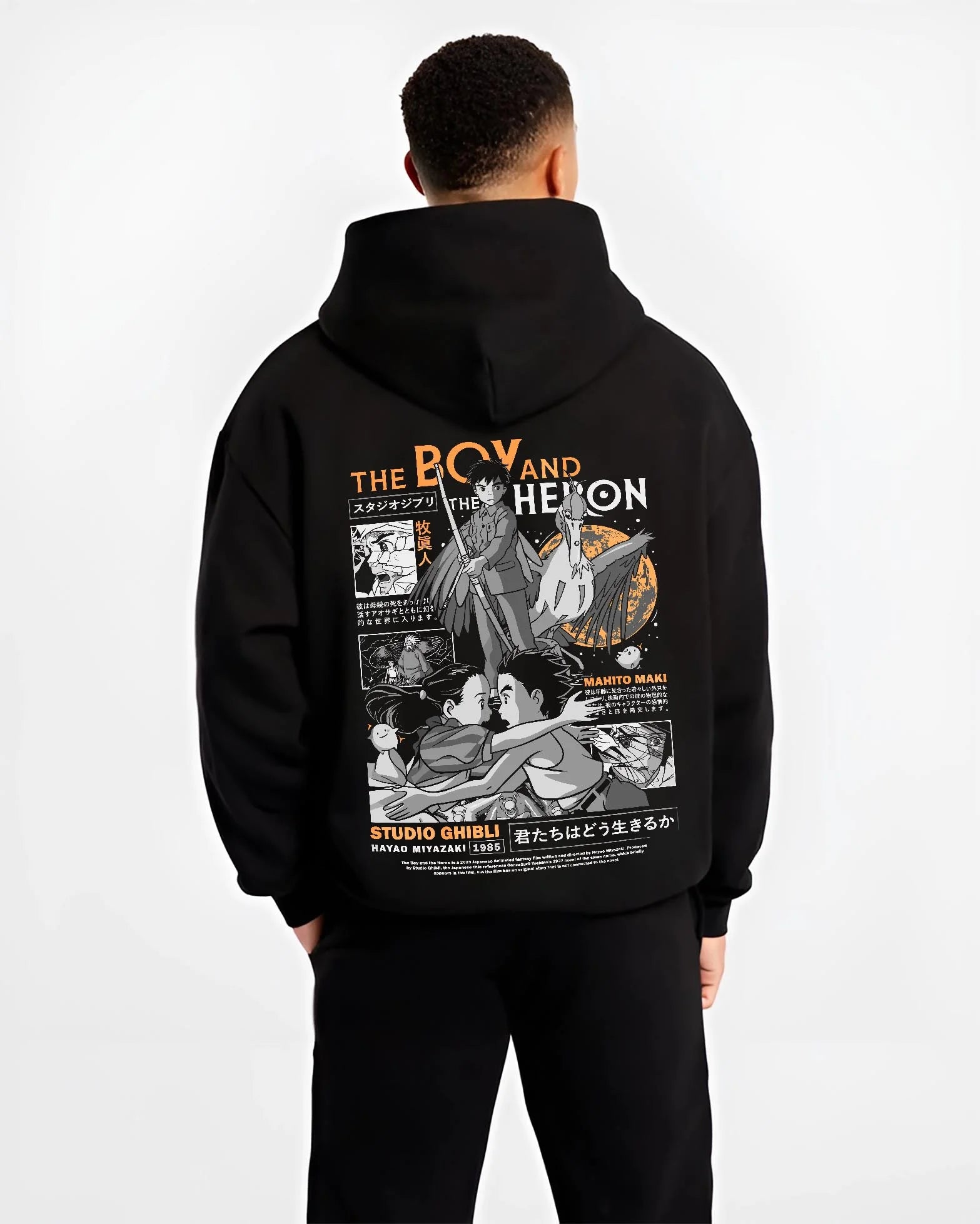 Black hoodie worn by male model, back view with The Boy And The Heron Hoodie Studio Ghibli Cover graphic streetwear graphic.