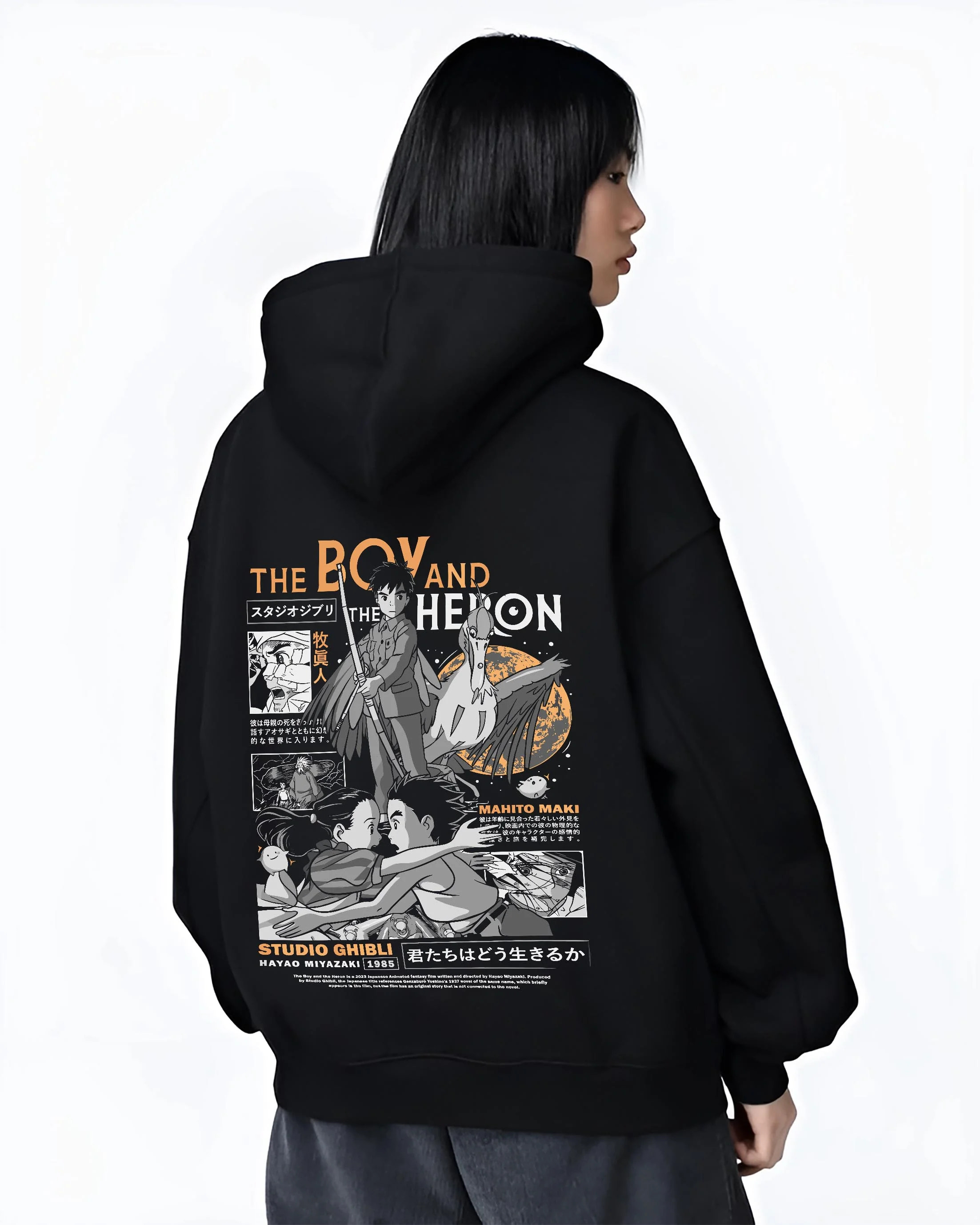 Black hoodie worn by female model, back view with The Boy And The Heron Hoodie Studio Ghibli Cover graphic nan themed artwork.