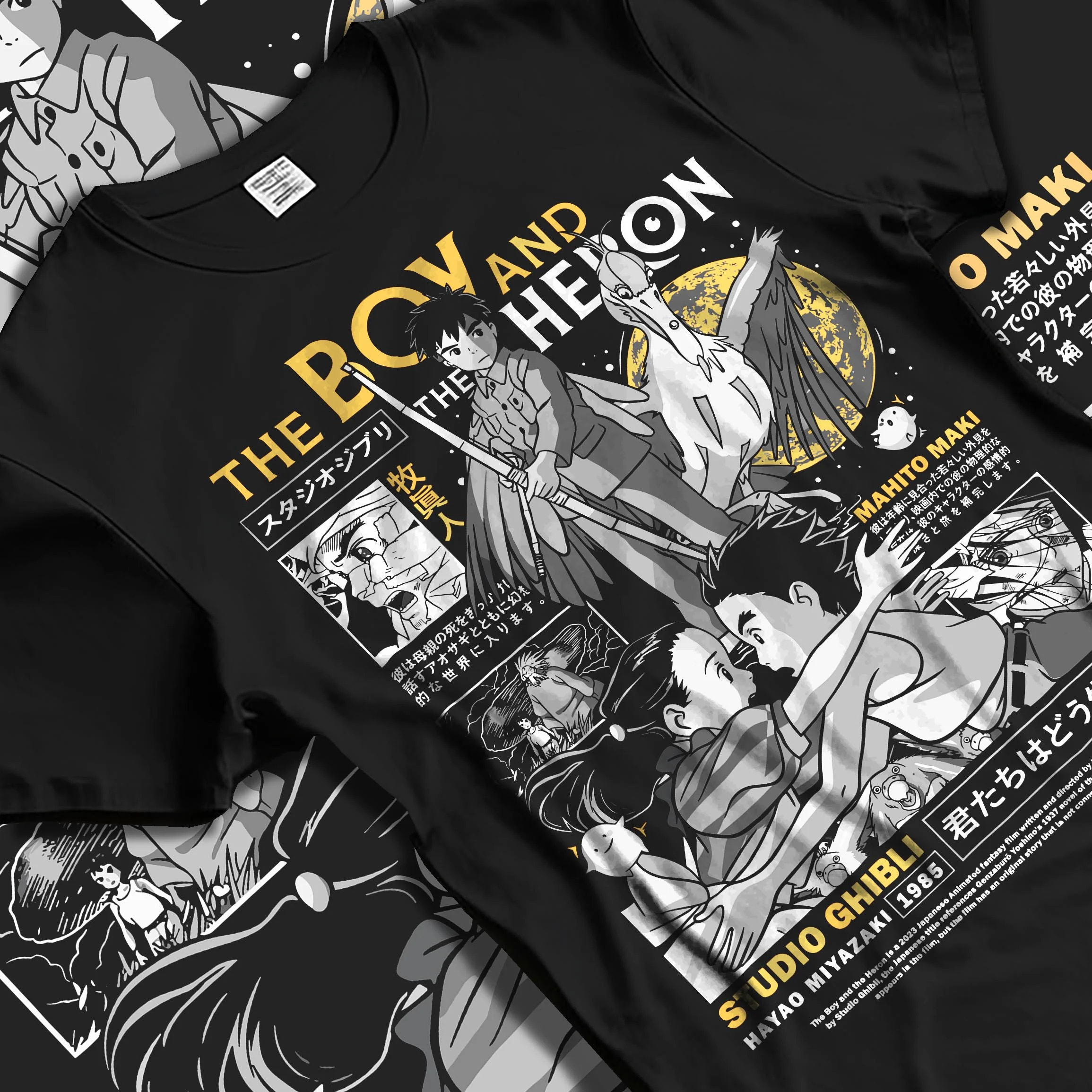 Black T-shirt laid flat with natural folds with The Boy And The Heron Hoodie Studio Ghibli Cover graphic bold anime graphic.