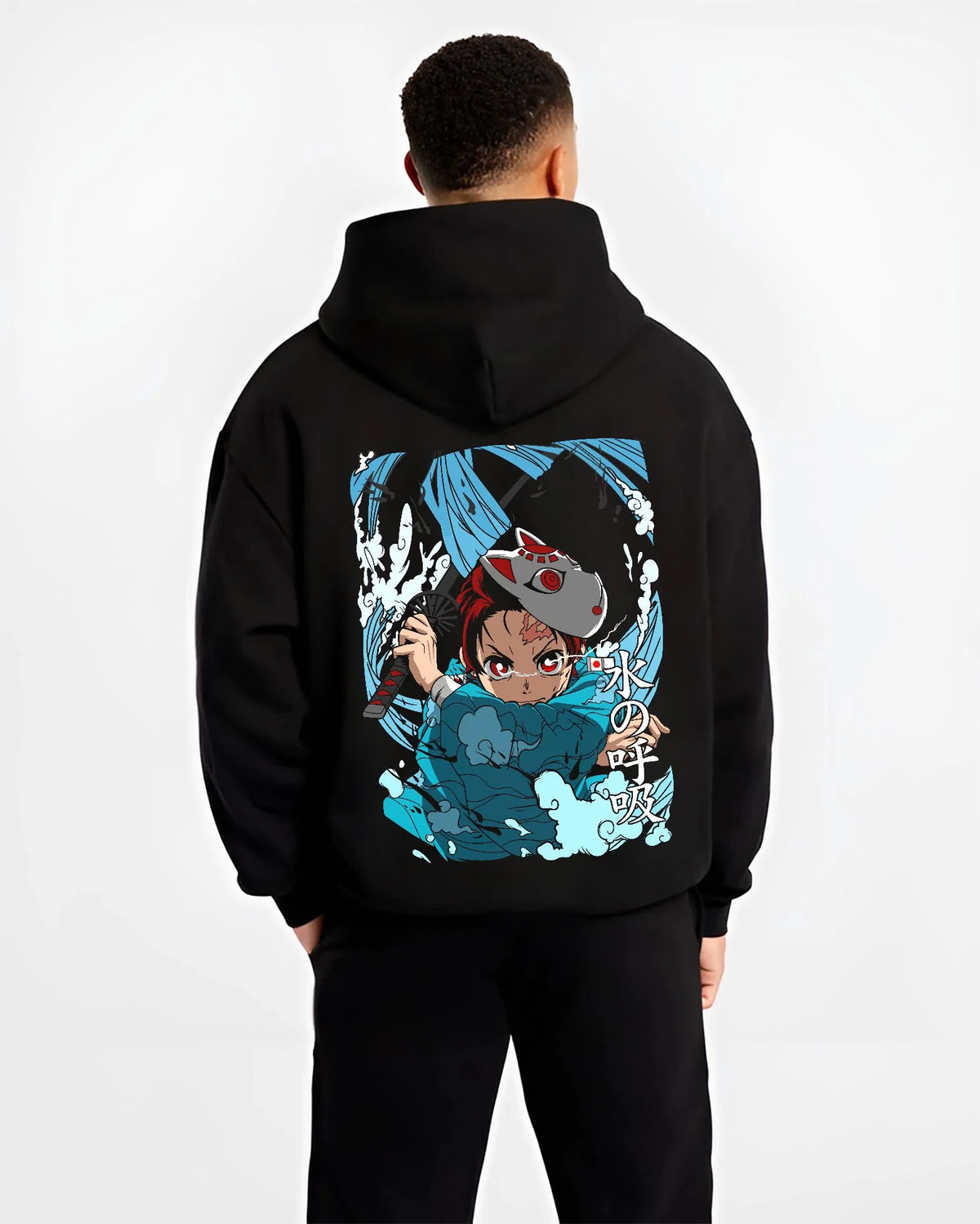 Black hoodie worn by male model from the back featuring Tanjiro Hinokami flame and water breathing artwork.