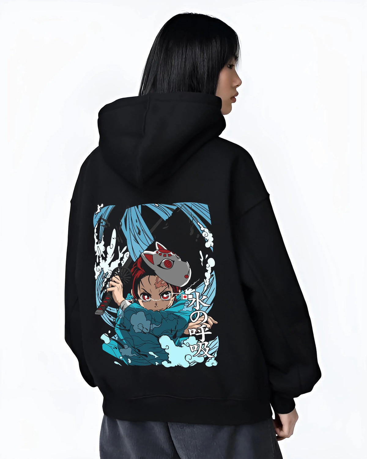 Black hoodie worn by female model from the back featuring Tanjiro Hinokami flame and water breathing artwork.