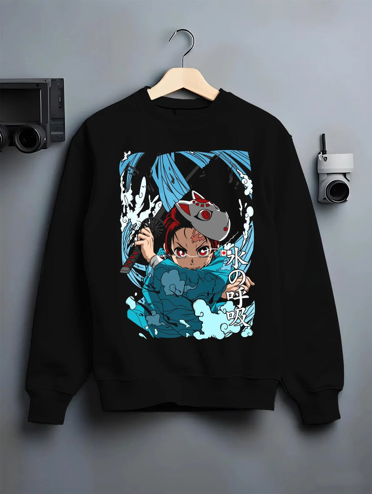 Black crewneck sweatshirt on hanger featuring Tanjiro Hinokami flame and water breathing artwork.