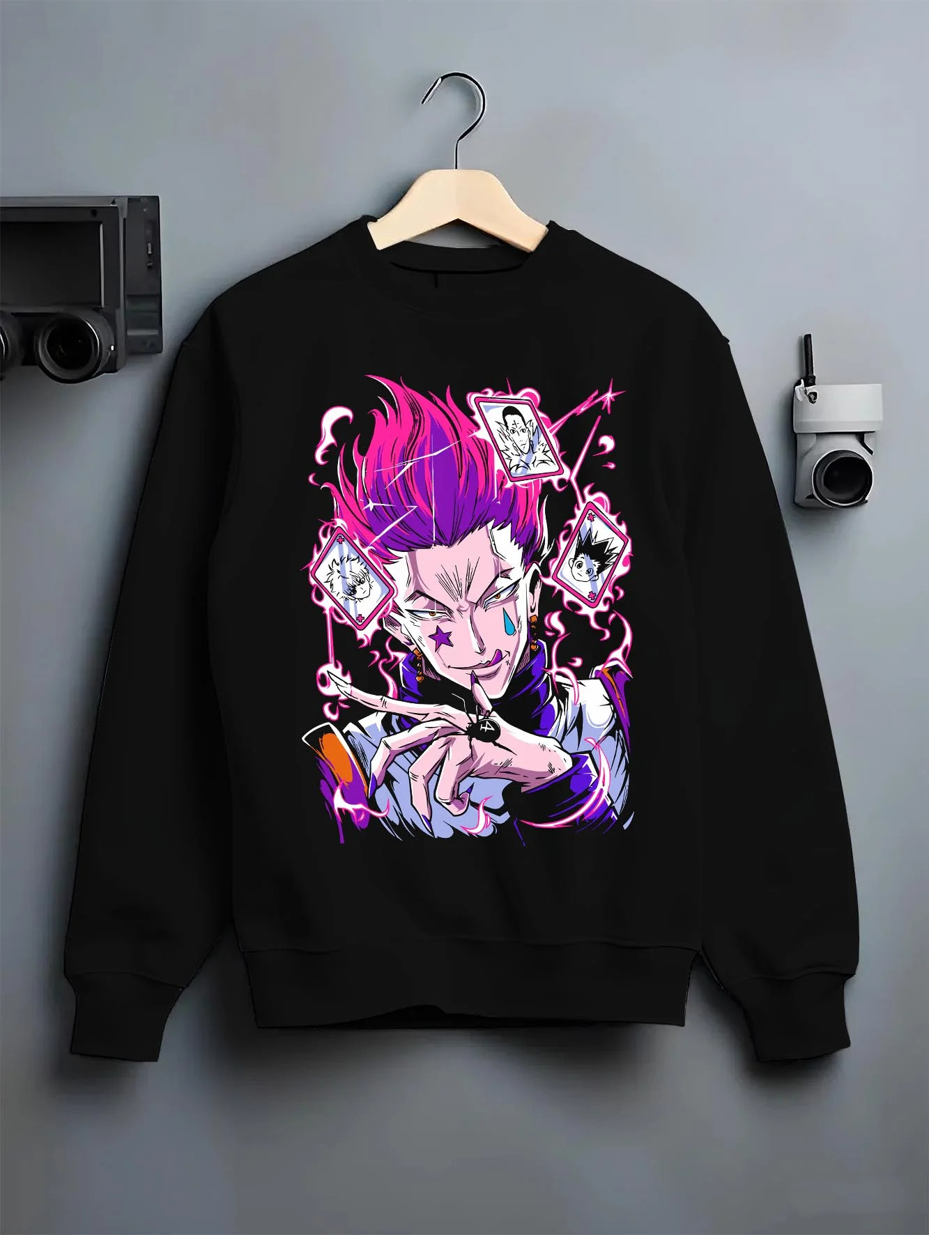 Black crewneck sweatshirt on hanger with Hunter x Hunter Hoodie Hisoka Card Trick Jumper graphic Hisoka anime design.