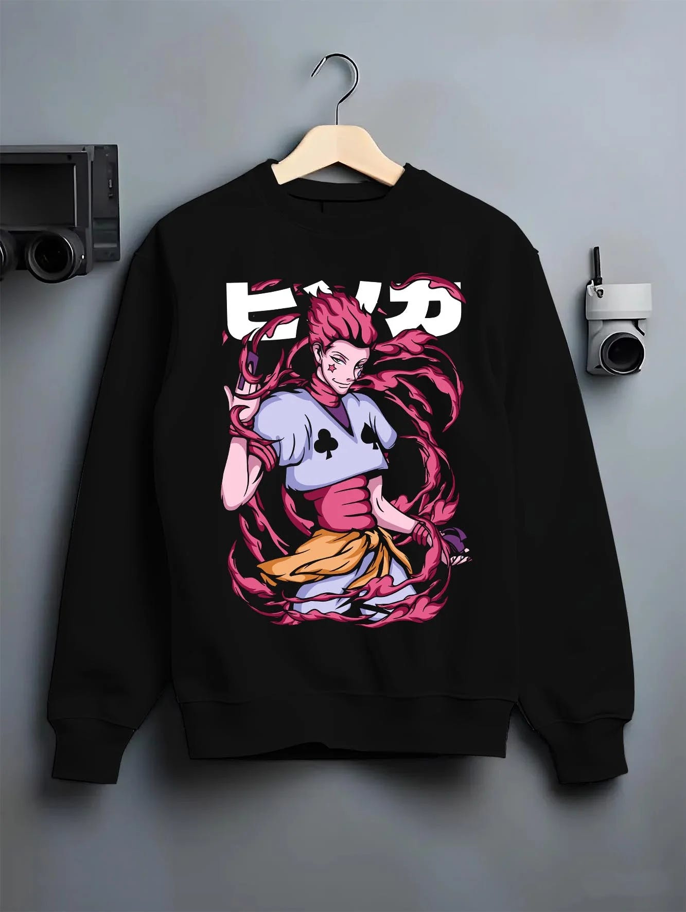 Black crewneck sweatshirt on hanger with Hunter x Hunter Hoodie Hisoka Deadly Clown Jumper graphic premium wear.