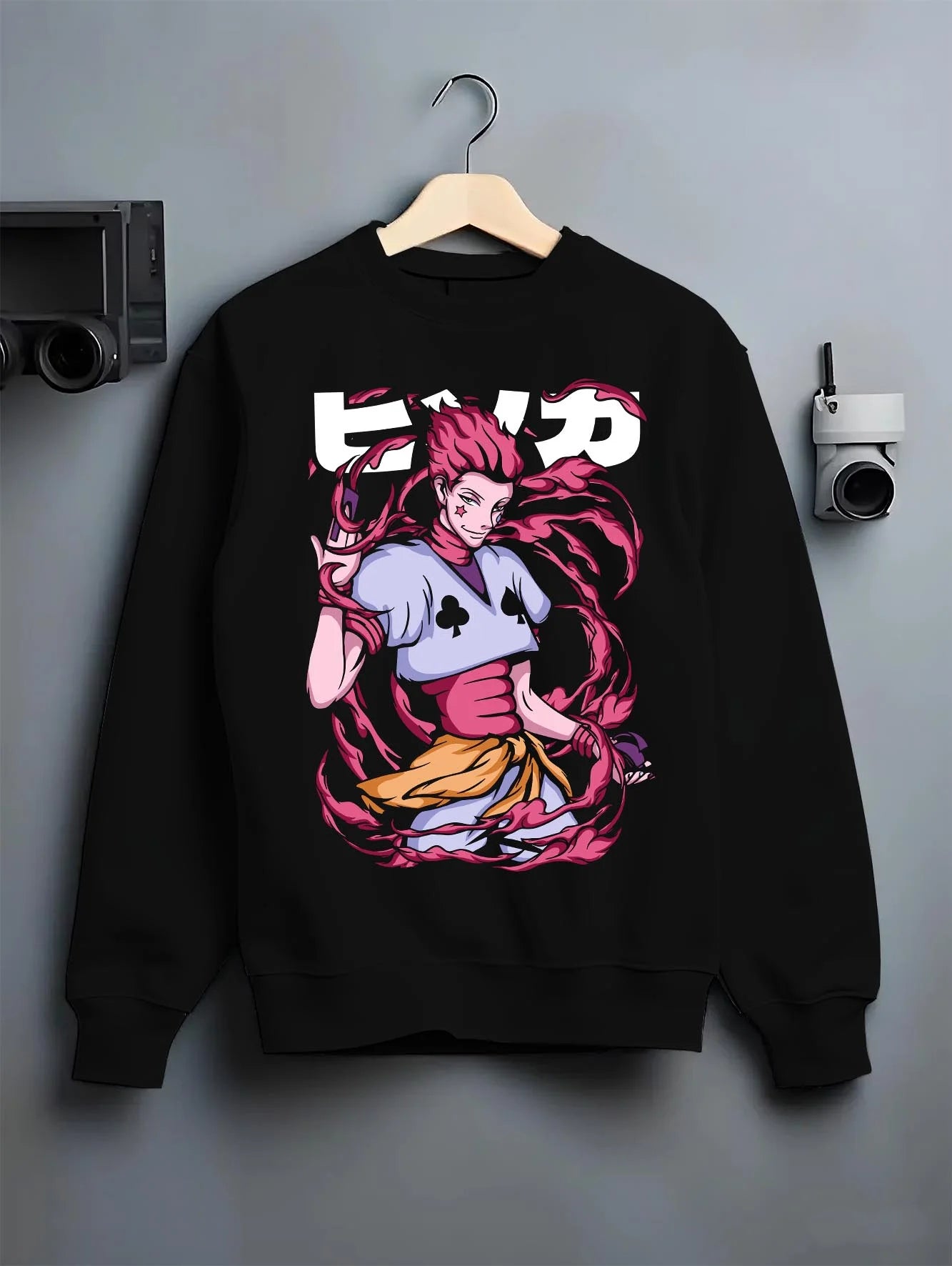 Black crewneck sweatshirt on hanger with Hunter x Hunter Hoodie Hisoka Deadly Clown Jumper graphic premium wear.