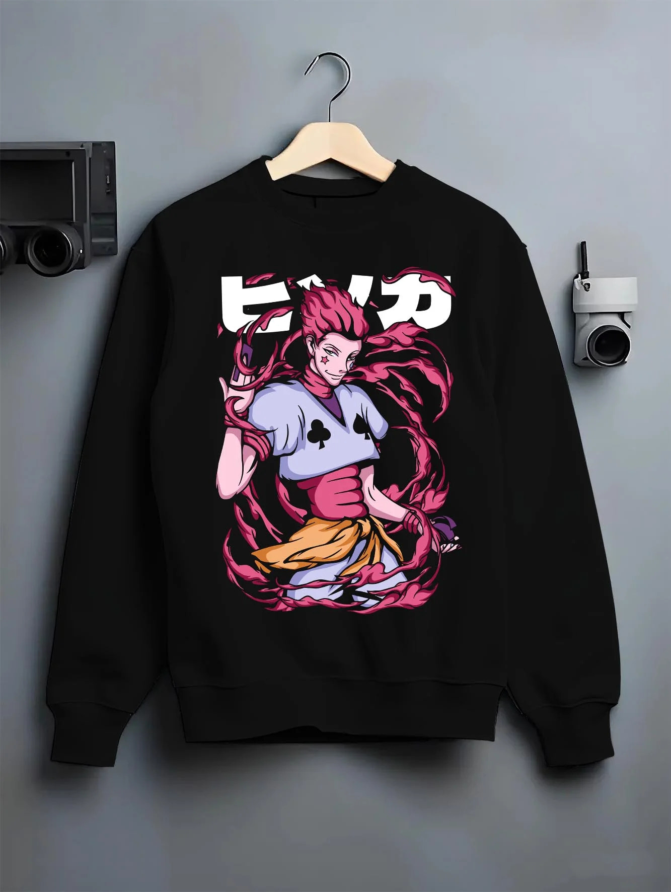 Black crewneck sweatshirt on hanger with Hunter x Hunter Hoodie Hisoka Deadly Clown Jumper graphic premium wear.