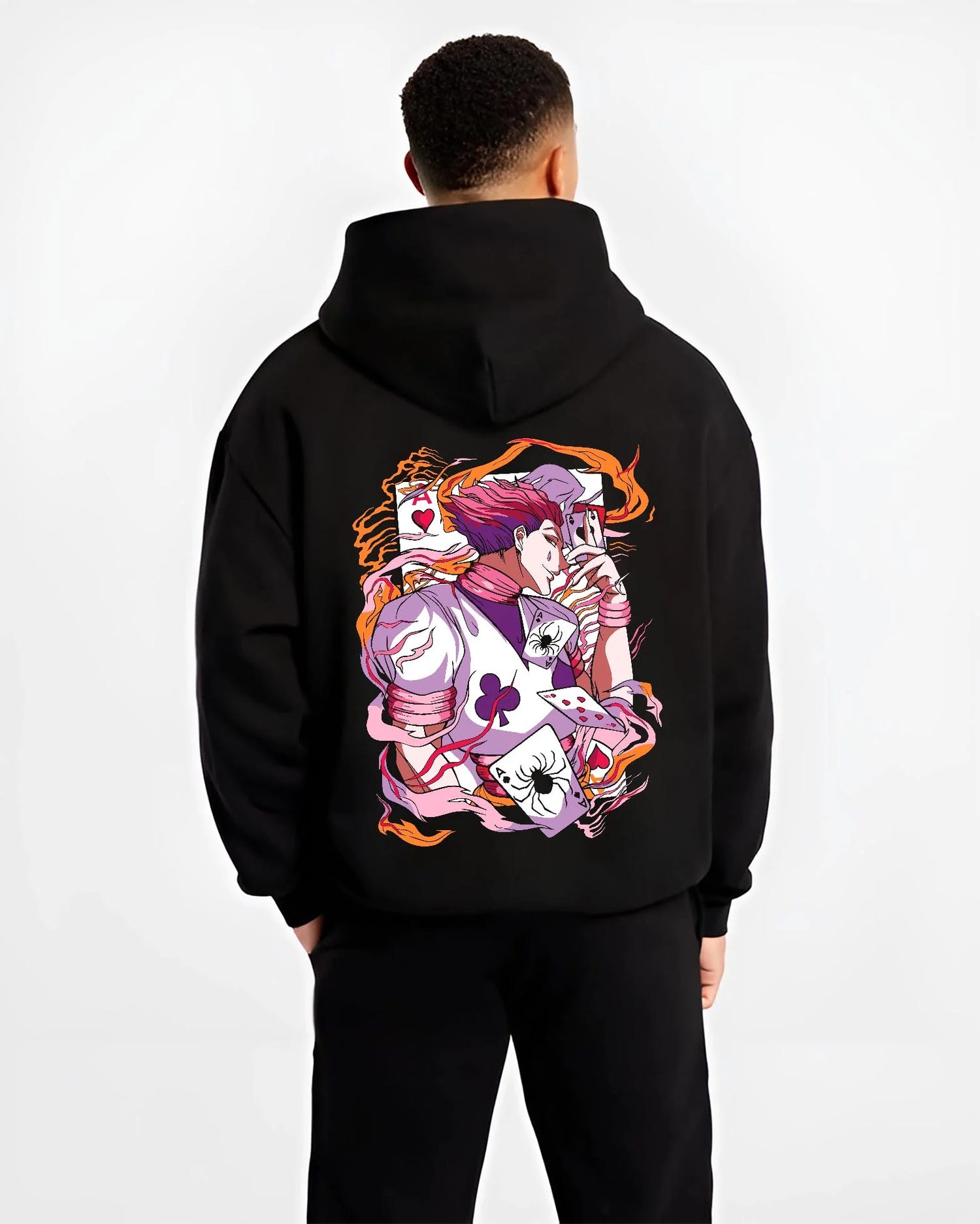 Black hoodie worn by male model, back view with Hunter x Hunter Hoodie Hisoka Joker Playing Card Jumper graphic premium wear.