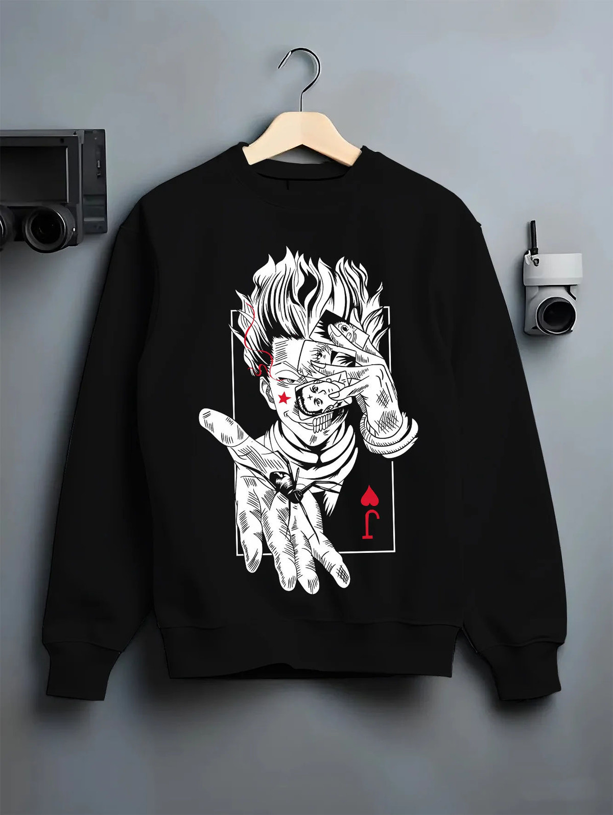 Black crewneck sweatshirt on hanger showing Hisoka Morow from Hunter x Hunter: playing-card illusionist