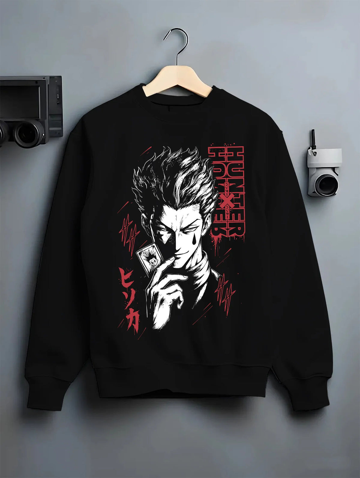 Black crewneck sweatshirt on hanger showing Hisoka Morow from Hunter x Hunter: dark stylised portrait
