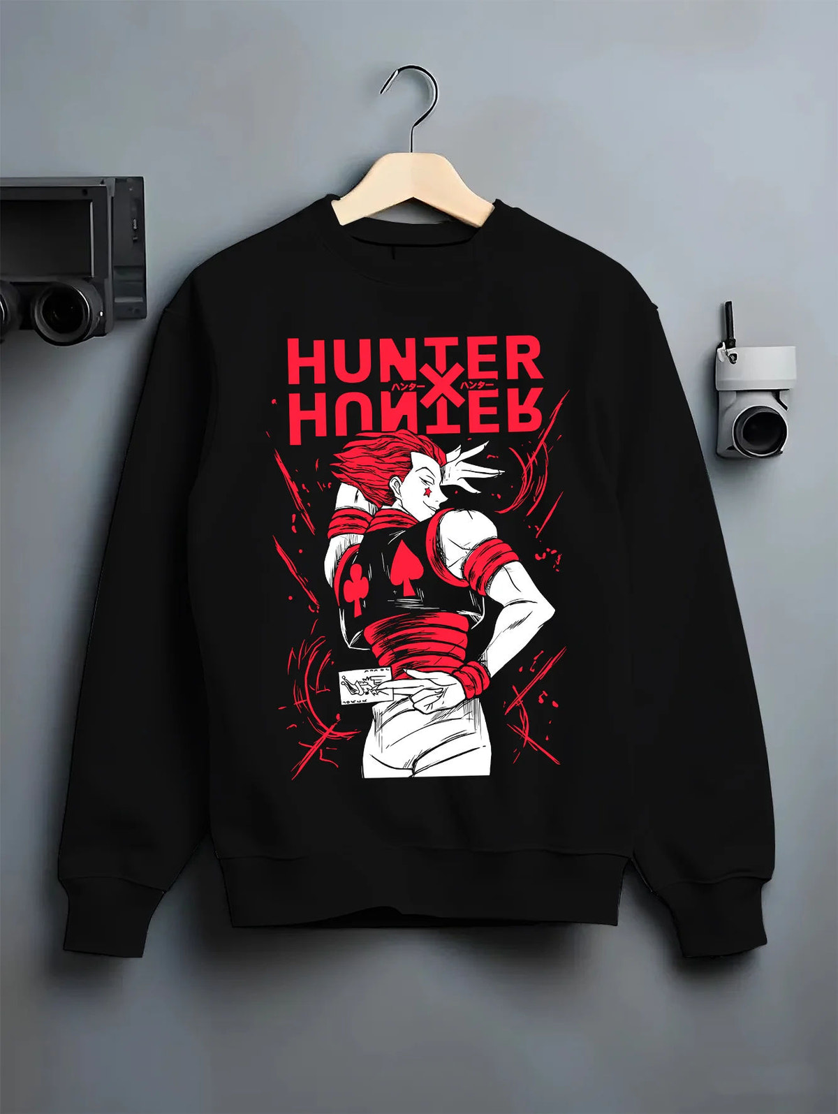 Black crewneck sweatshirt on hanger showing Hisoka Morow from Hunter x Hunter: red-black outfit
