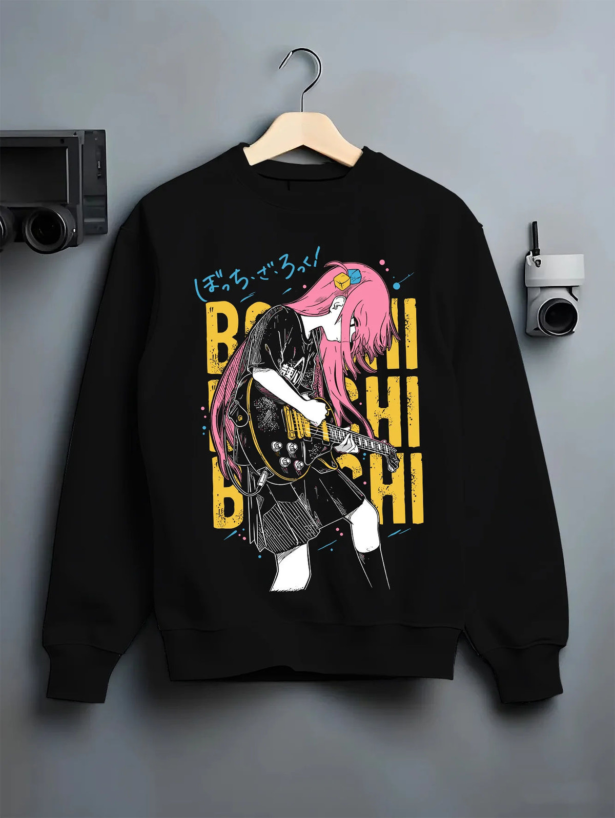 Black crewneck sweatshirt on hanger showing Hitori Gotoh / Bocchi from Bocchi the Rock!: guitar pose