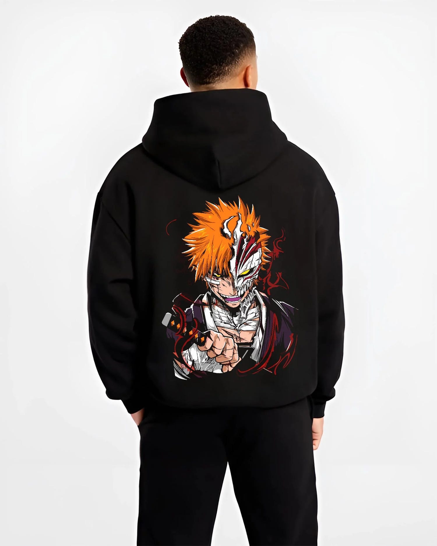 Black hoodie worn by male model, back view with Ichigo Hollow Mask Hoodie Bleach Vizard Form Battle graphic streetwear graphic.