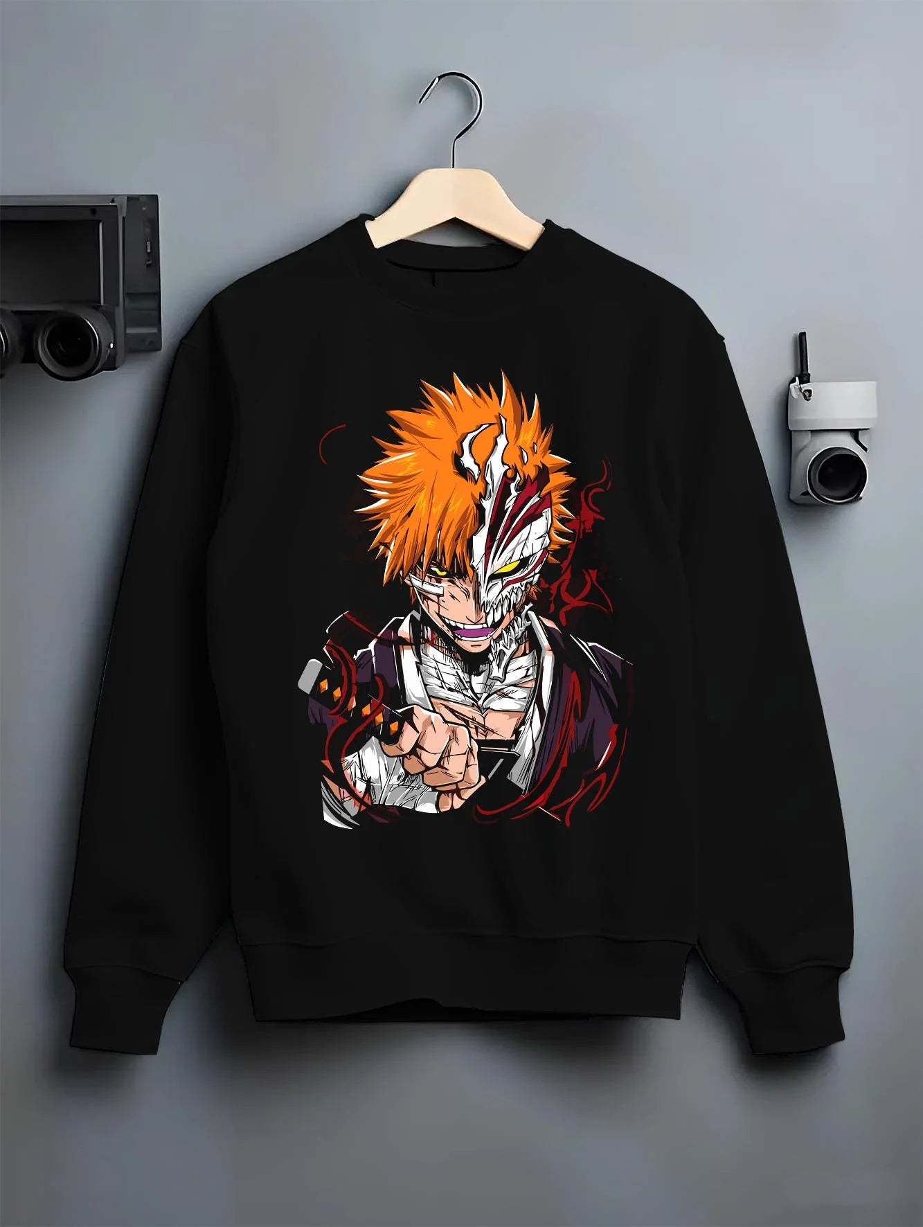 Black crewneck sweatshirt on hanger with Ichigo Hollow Mask Hoodie Bleach Vizard Form Battle graphic bold anime graphic.